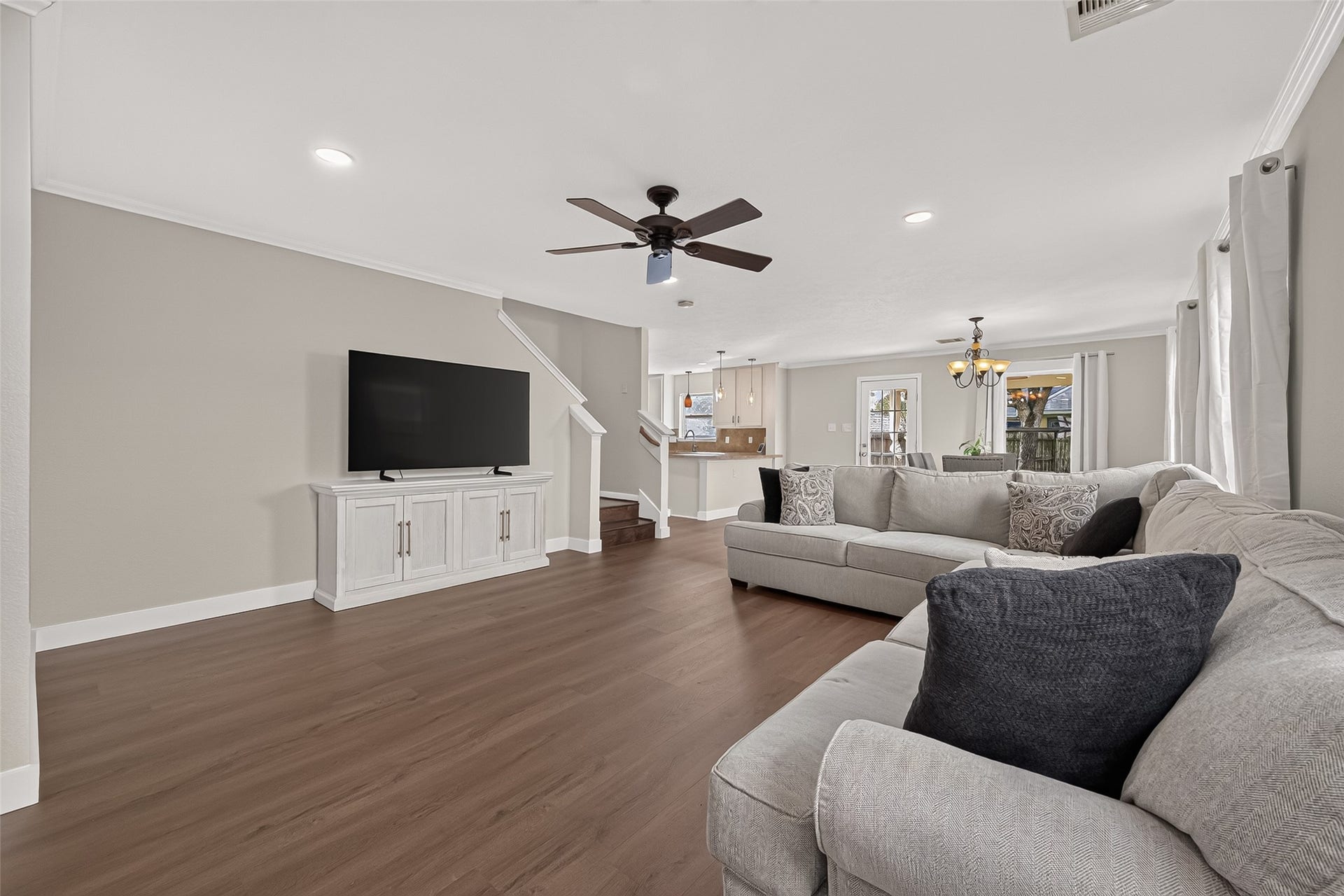 18019 Rexine Lane, Cypress, TX 77433 Spacious living area featuring elegant vinyl plank floors seamlessly flowing into an open kitchen and dining space.