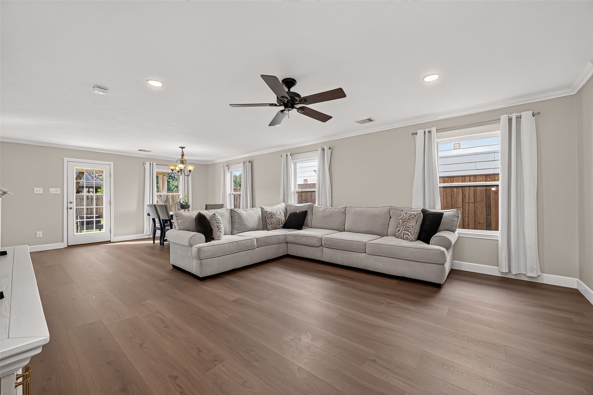 18019 Rexine Lane, Cypress, TX 77433 Spacious living area with elegant vinyl plank flooring, abundant natural light from large windows.