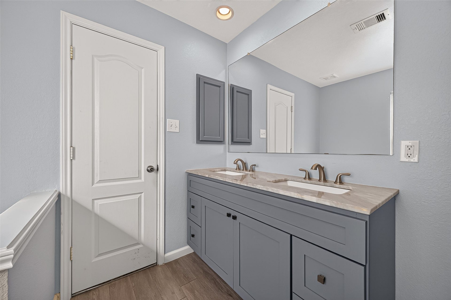 18019 Rexine Lane, Cypress, TX 77433 Stylish secondary bathroom featuring a double vanity with elegant fixtures, ample storage, and a large mirror, all in a soothing neutral palette.