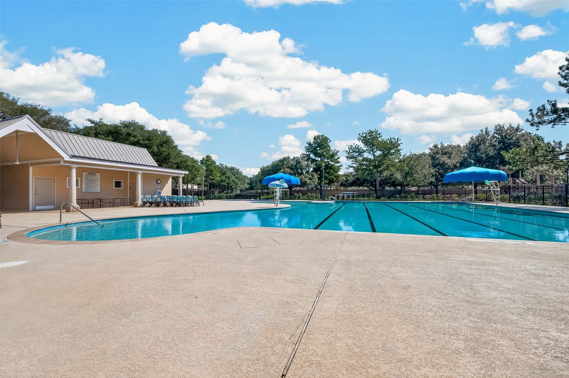 18019 Rexine Lane, Cypress, TX 77433 Enjoy a refreshing swim in this spacious community pool, featuring ample deck space and shaded seating, perfect for relaxation and gatherings.