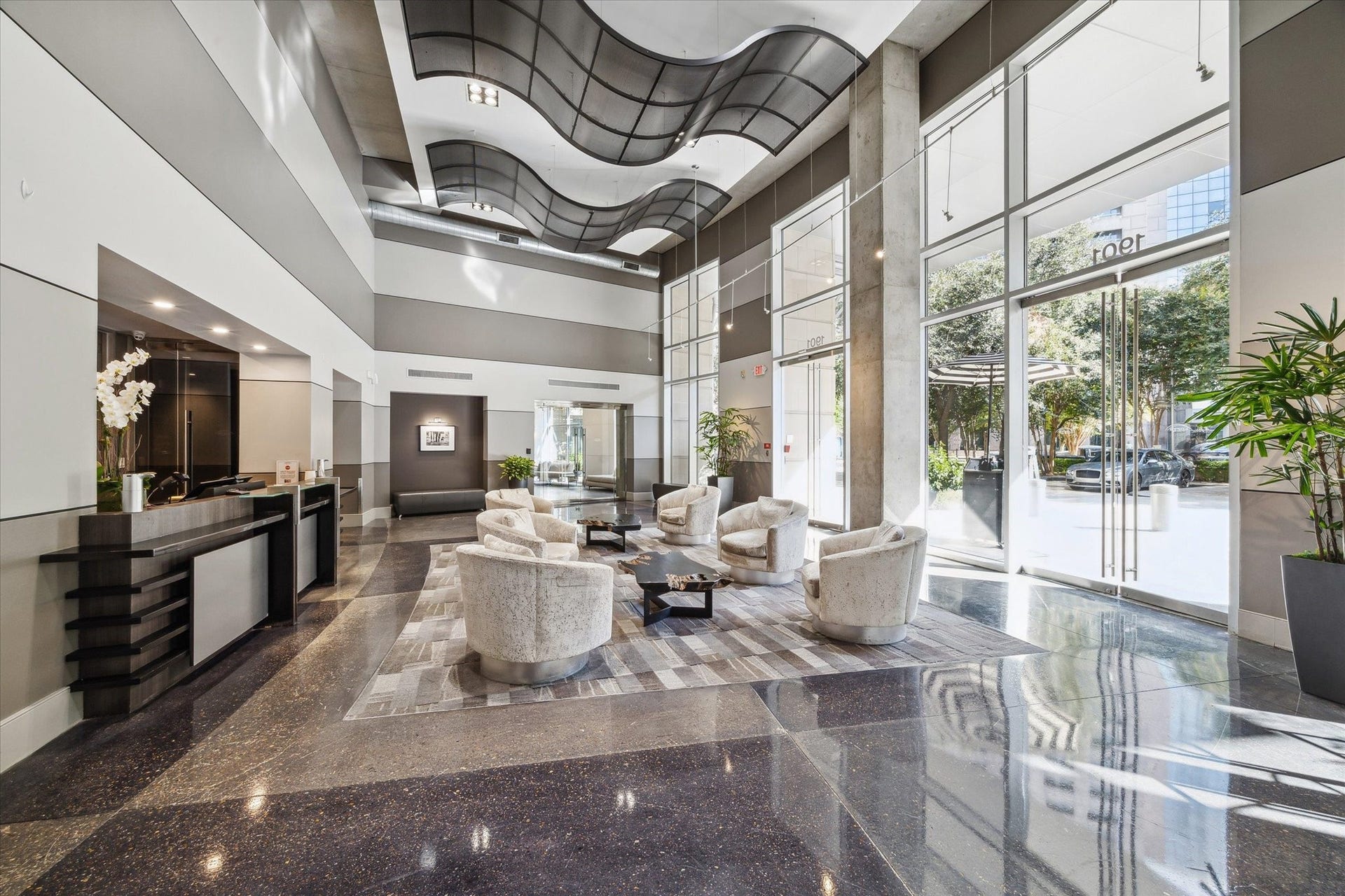 Sophisticated lobby with high ceilings, modern decor, and abundant natural light, featuring stylish seating and a sleek reception area.  Valet your car, pick up your packages, grab your food order or coffee from the coffee bar and head home.  I hang out in the lobby and meet your neighbors.  Fun and social building.