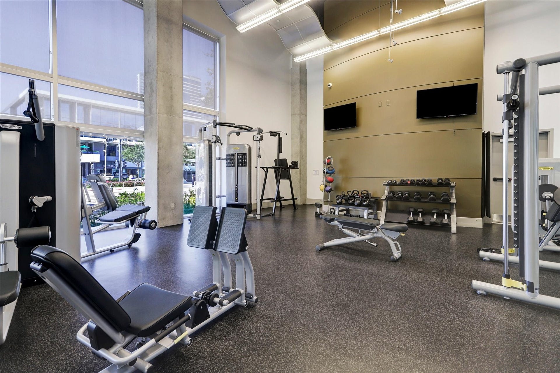 State-of-the-art fitness center featuring a spacious layout perfect for all your workout needs.  No need to join a gym with this right in the building.  Not shown are the stair machines and treadmills with a great view of a lush courtyard.