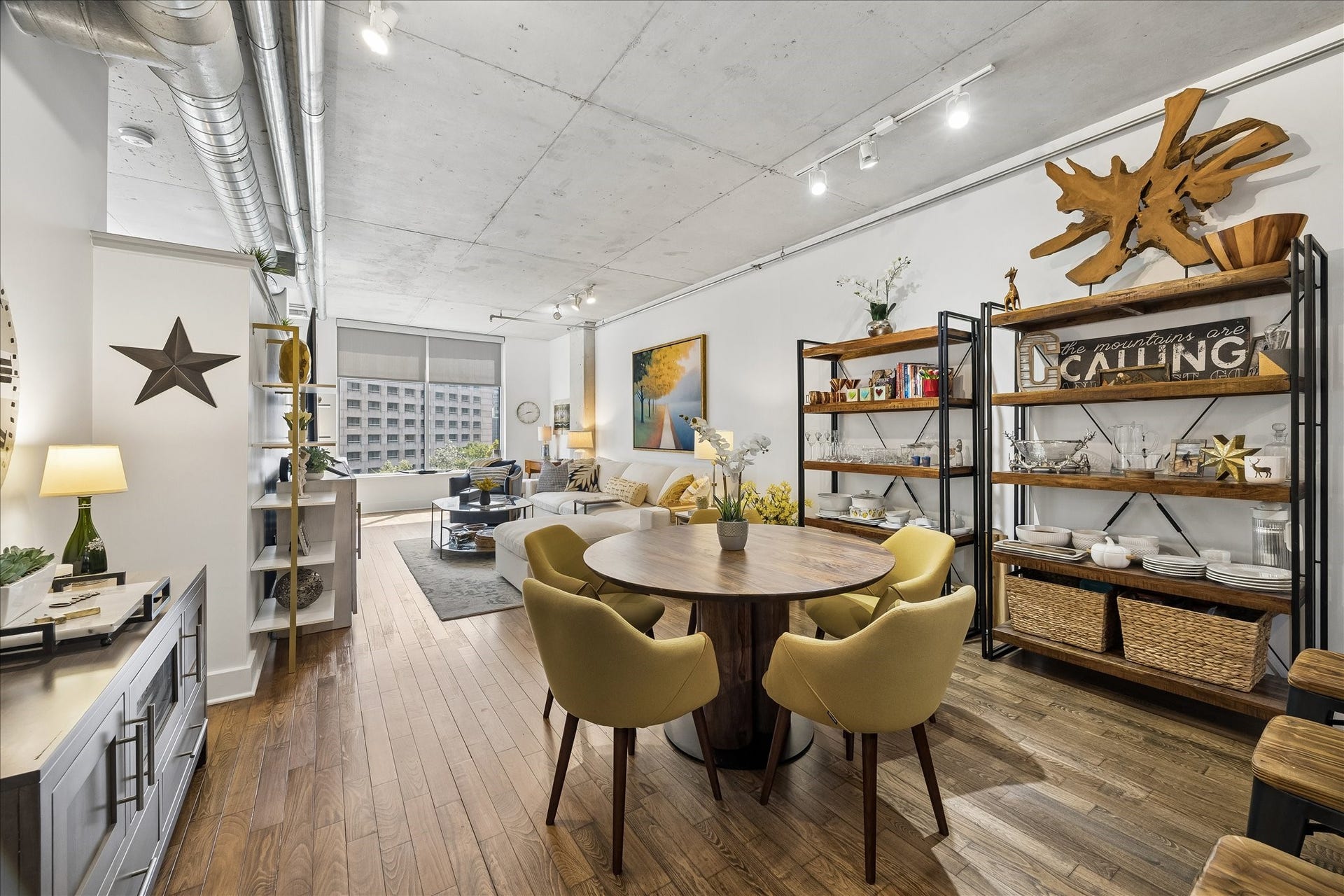 Exposed duct work, concrete ceilings, track lighting and white walls are the perfect for creating a cool and chic atmosphere.