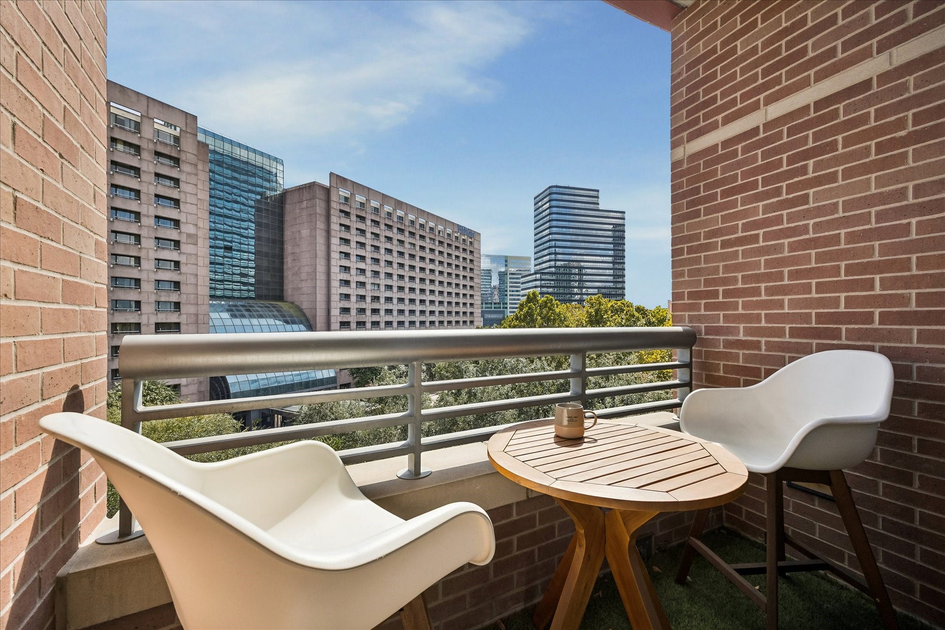 Charming private balcony off the primary bedroom, offers stunning city views, perfect for relaxing or enjoying a morning coffee or afternoon beverage.