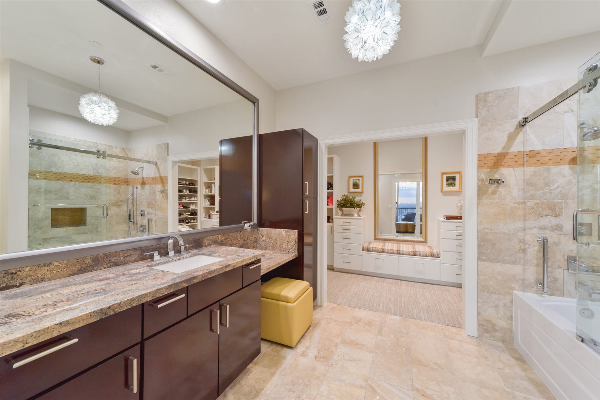 3333 Allen Parkway, #3003, Houston, TX 77019 One of two generously sized primary bathrooms, this one includes space for a seated vanity as well as a large tub and shower. This bathroom leads to one of two primary closets.