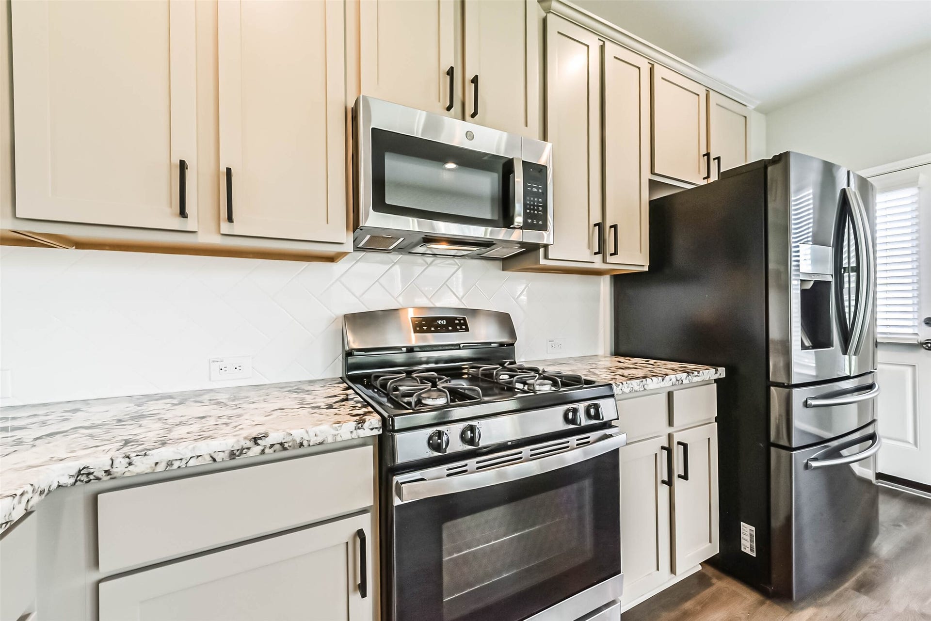 Granite countertops and stainless steel appliances.