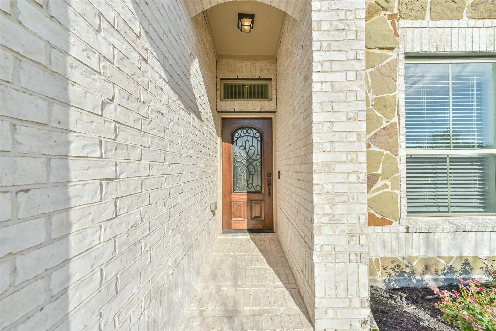 Upgraded exterior front door, sconces and refreshed landscaping.