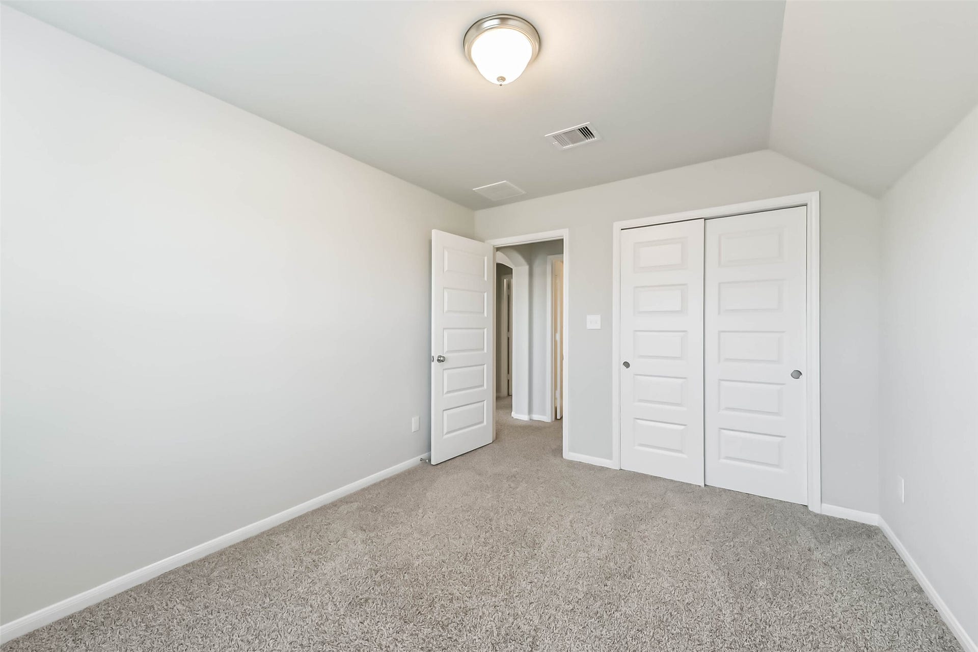 Spacious secondary bedroom with ample closet space.