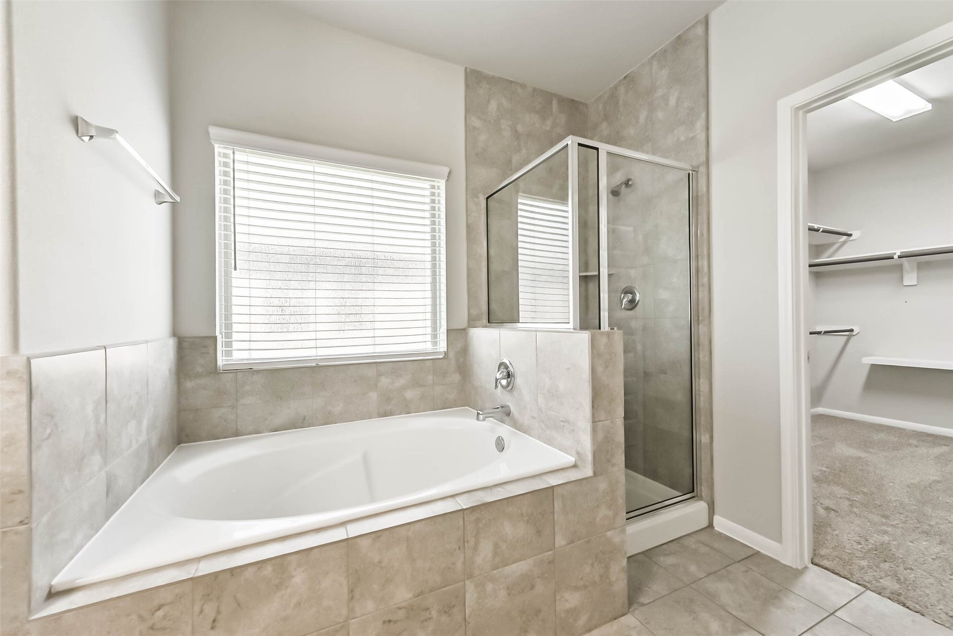 Spacious primary bath with separate tub and shower.