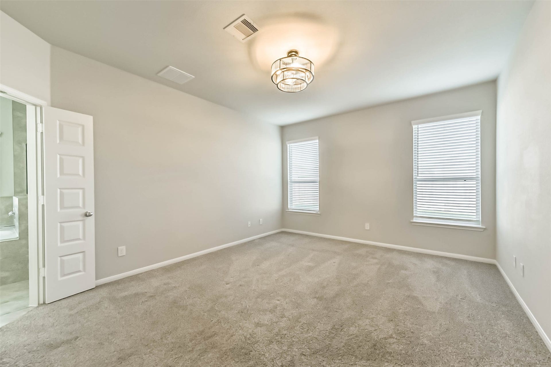 Private primary suite with plenty of natural light.