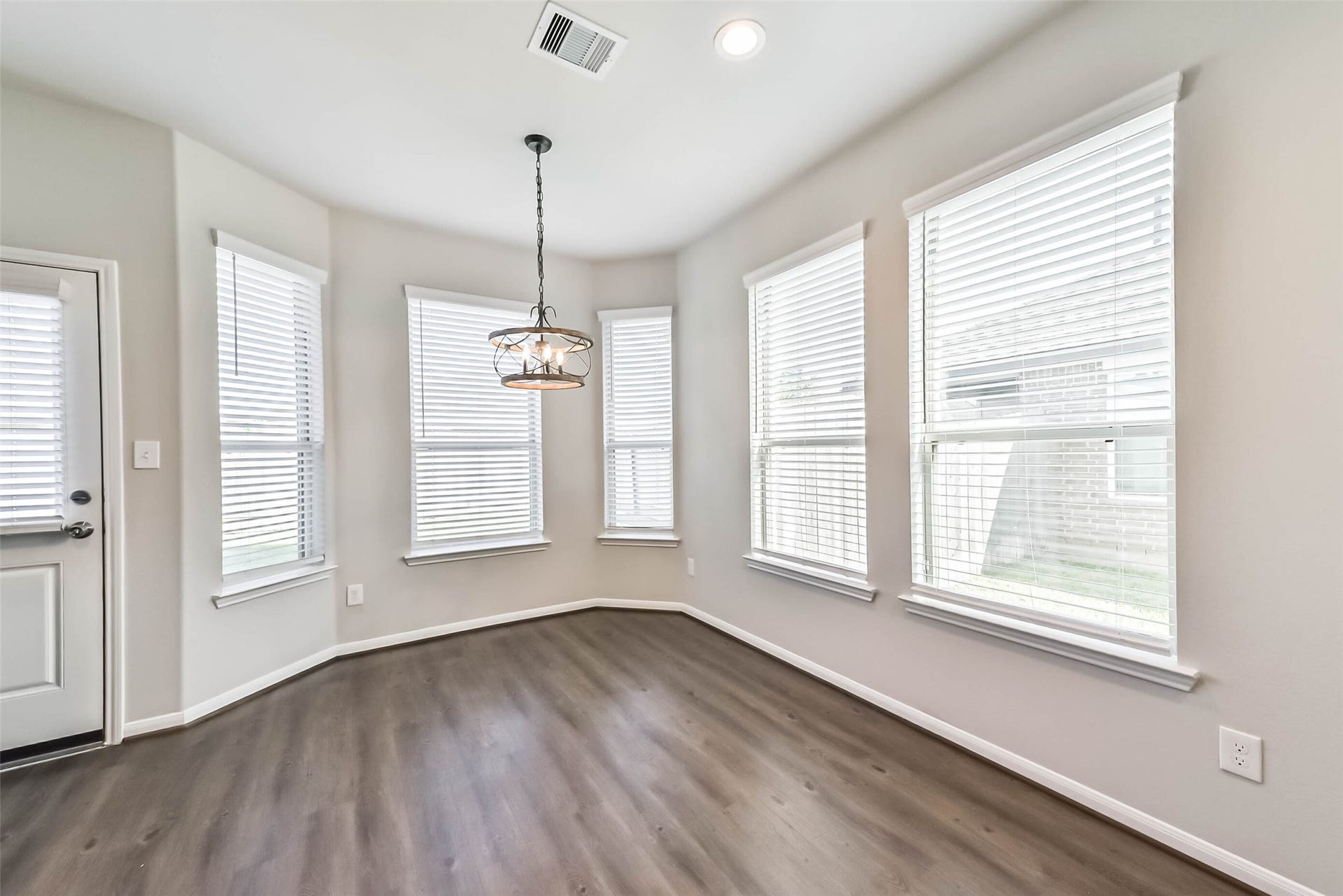 Spacious breakfast area surrounded by natural light.