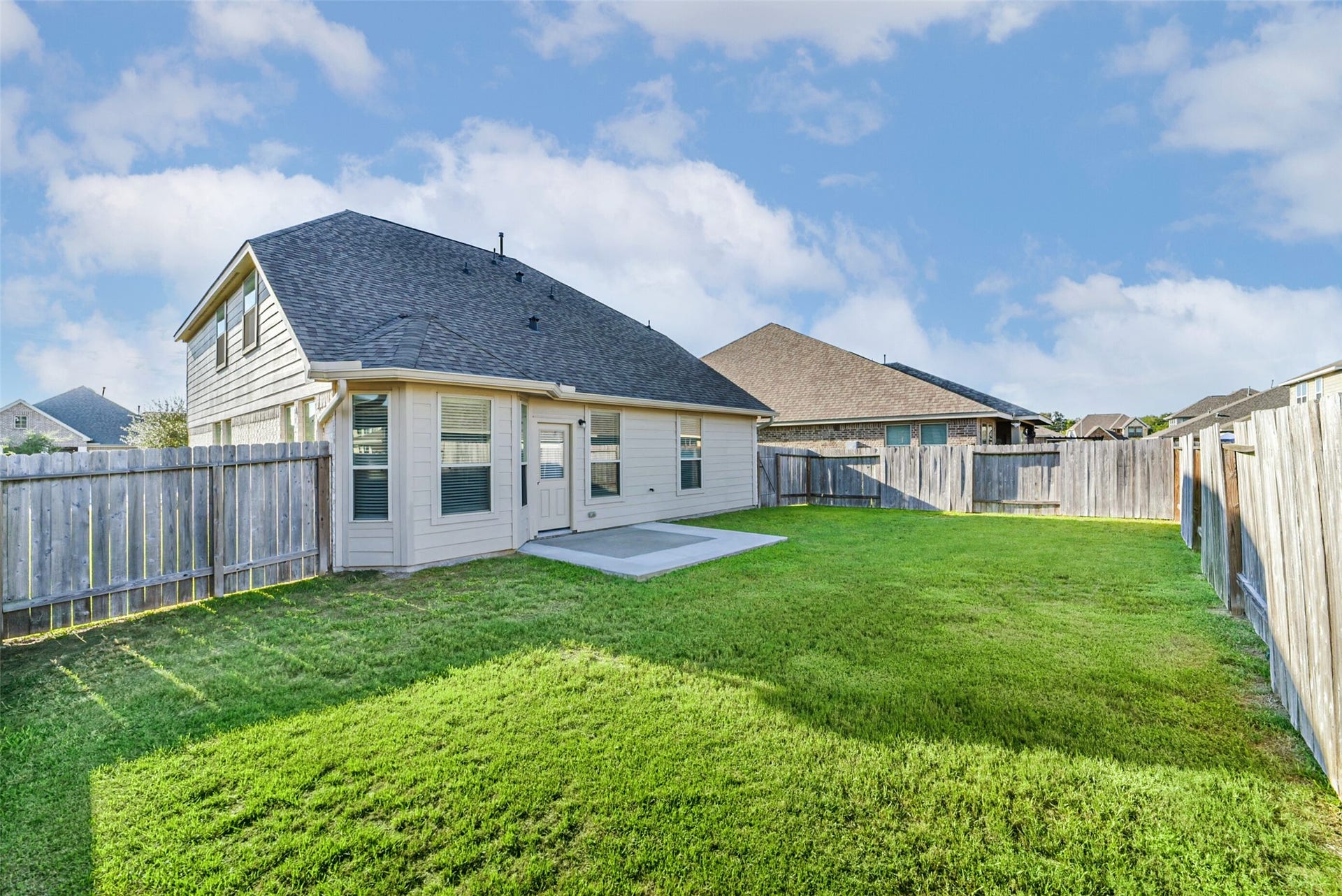 Extended concrete patio perfect for outdoor gatherings.