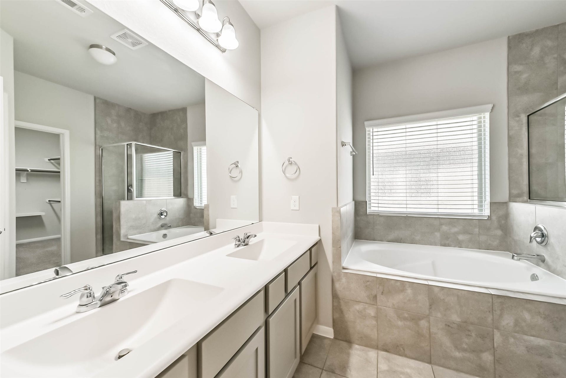 Primary bath features dual sinks and separate shower.