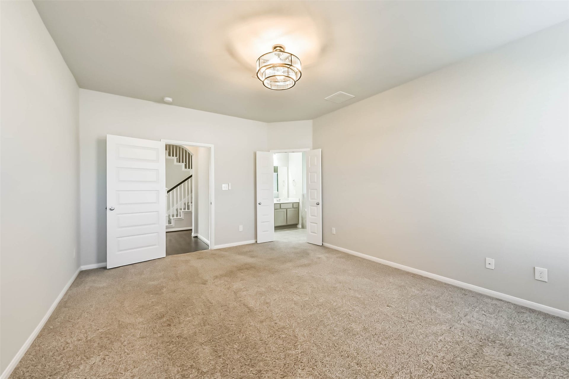 Spacious primary bedroom with comfortable layout.