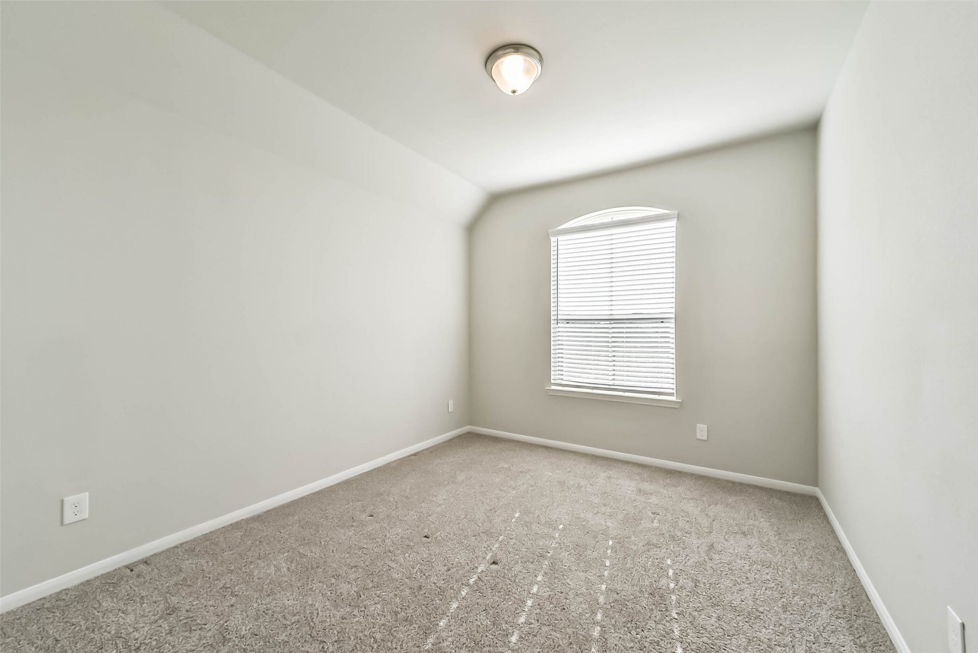 Generously sized secondary bedroom with natural light.