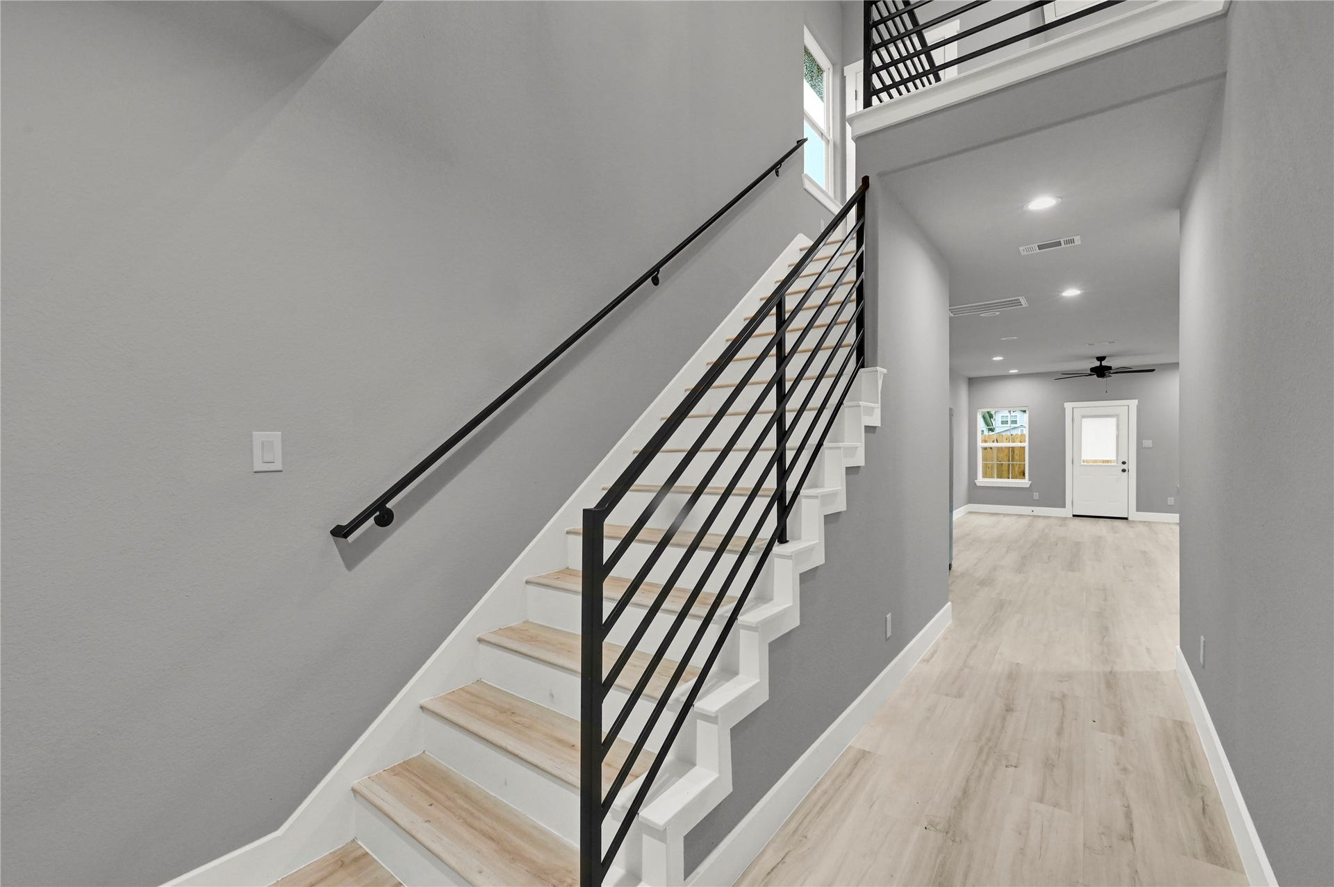 7415 Hezekiah Ln, #B, Houston, TX 77088 Entry way with custom railing for the staircase.