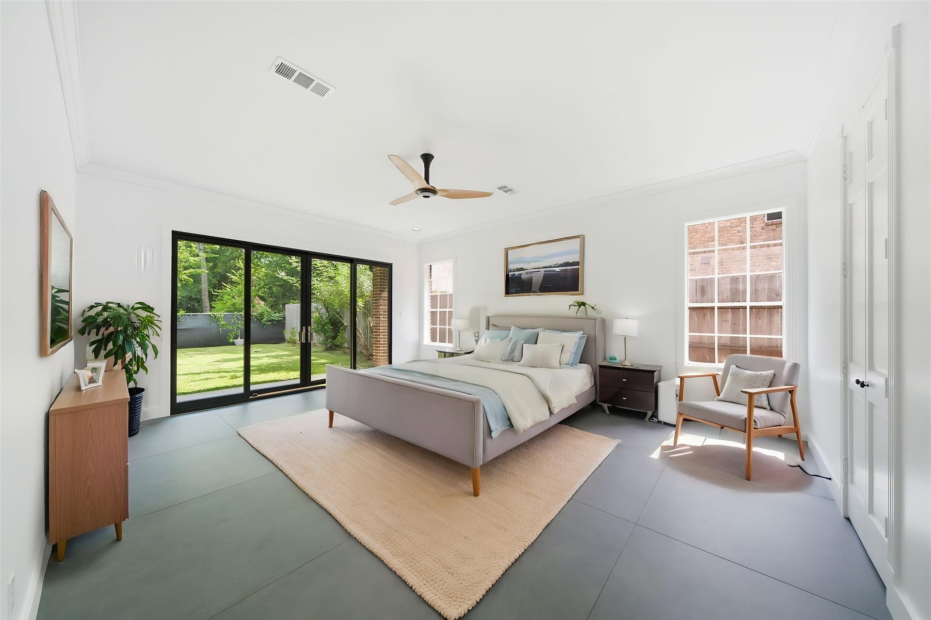14 Hilshire Grove Lane, Hilshire Village, TX 77055 First Floor Primary Bedroom with views of the backyard. Photo is virtually staged.