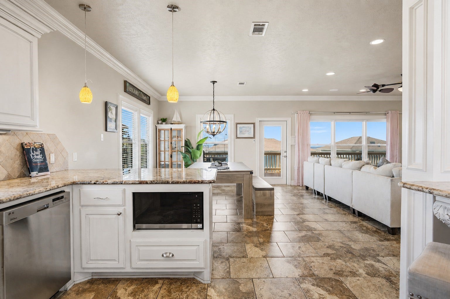 819 Eastview, Crystal Beach, TX 77650 From the kitchen, everything stays connectedfrom meals at the table to relaxing in the living room and stepping outside onto the balcony.