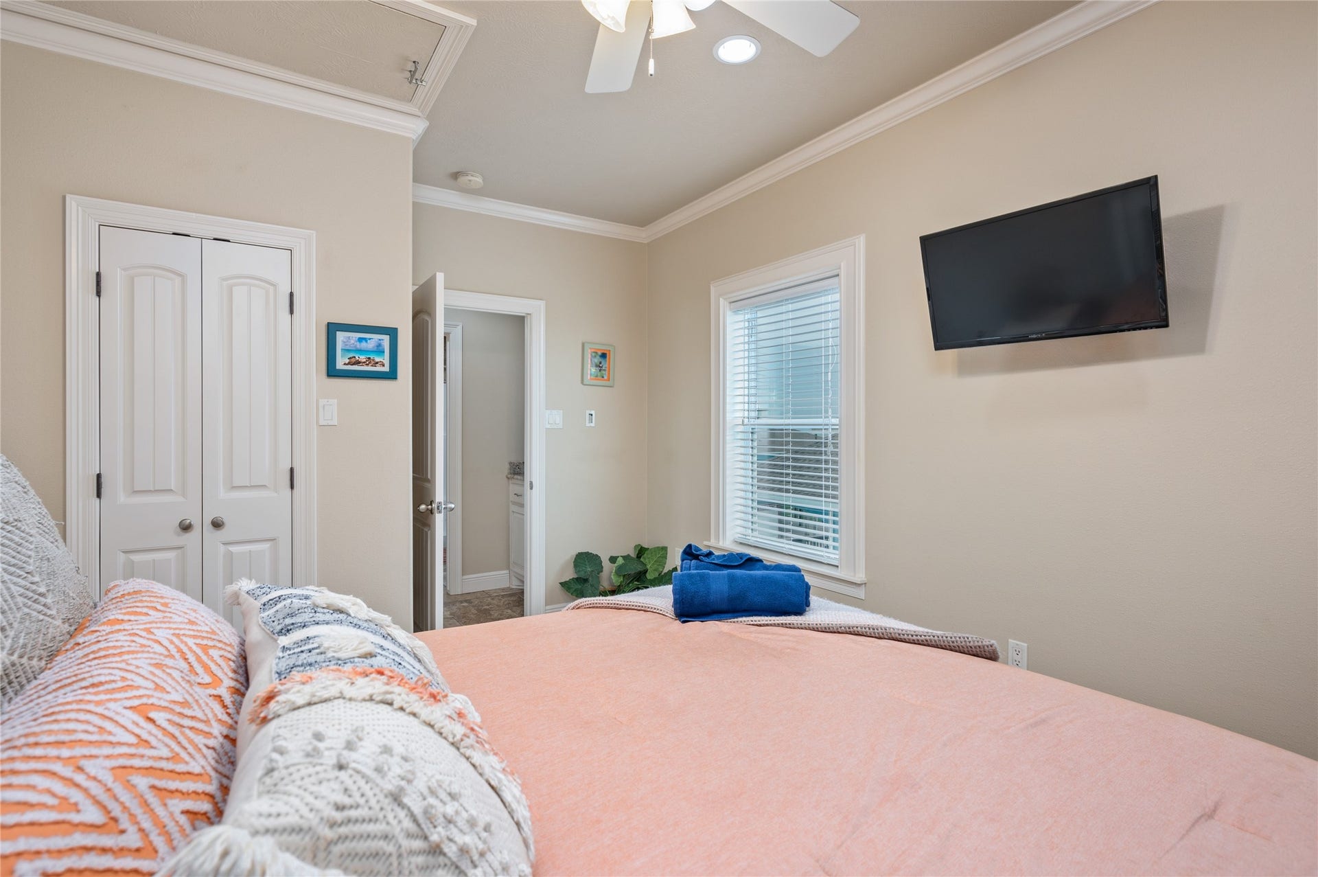 819 Eastview, Crystal Beach, TX 77650 Wake up in this comfortable bedroom with a wall-mounted TV, crown molding, and your own private bath just steps away.