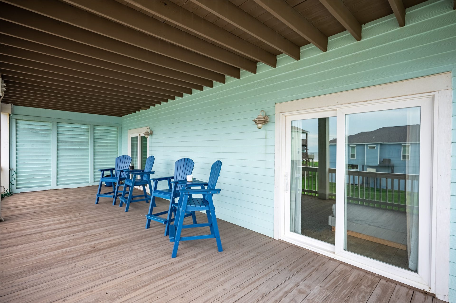 819 Eastview, Crystal Beach, TX 77650 Slide open the doors from your bedroom and enjoy a private covered retreat made for slow mornings and breezy evenings.