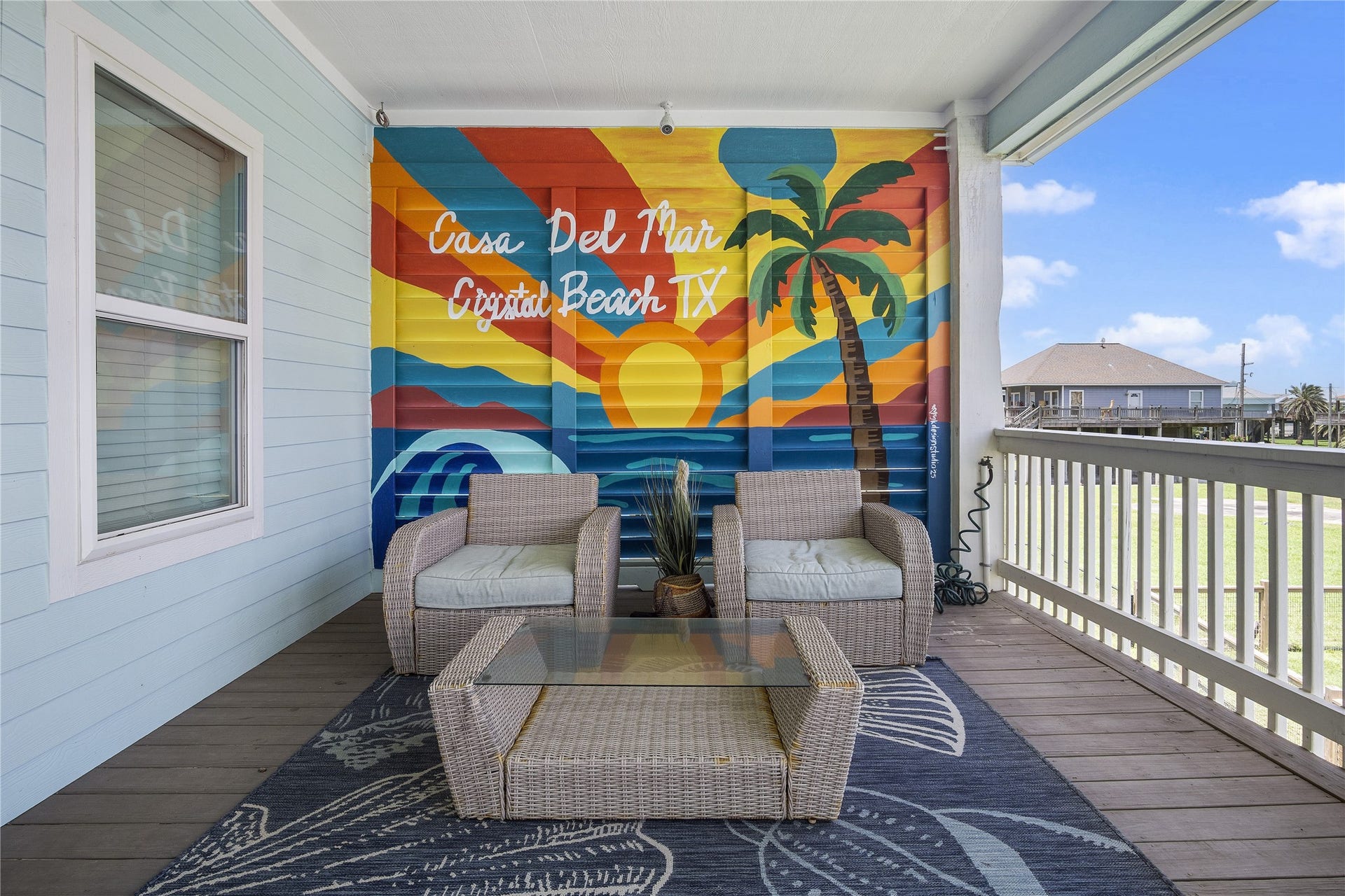 819 Eastview, Crystal Beach, TX 77650 Morning coffee has its own favorite spot on this covered balcony, complete with comfortable seating and a colorful Crystal Beach mural.