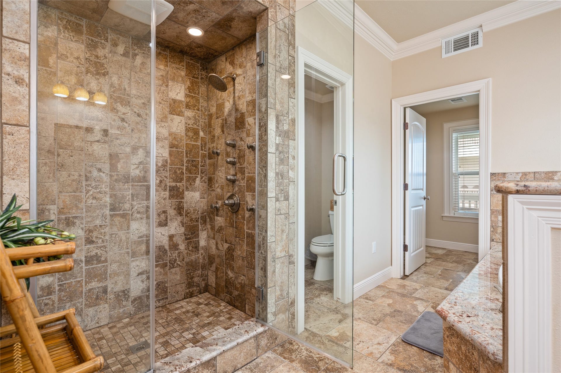 819 Eastview, Crystal Beach, TX 77650 Step into your spacious tiled walk-in shower, complete with a frameless glass enclosure and multiple shower fixtures for a spa-like start to the day.