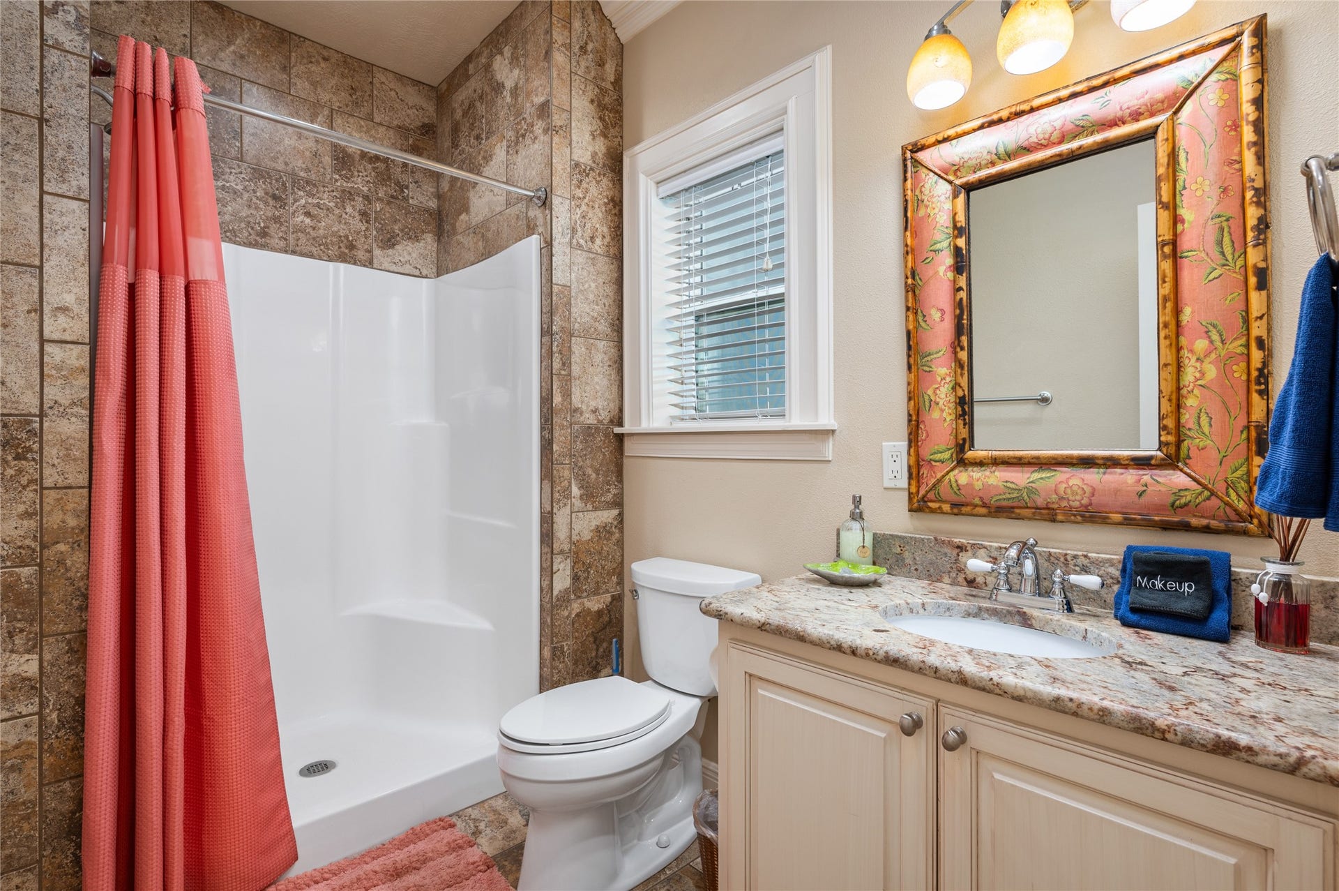819 Eastview, Crystal Beach, TX 77650 Your private bathroom features a granite-topped vanity and tiled shower surround, making everyday routines easy after a day at the beach.