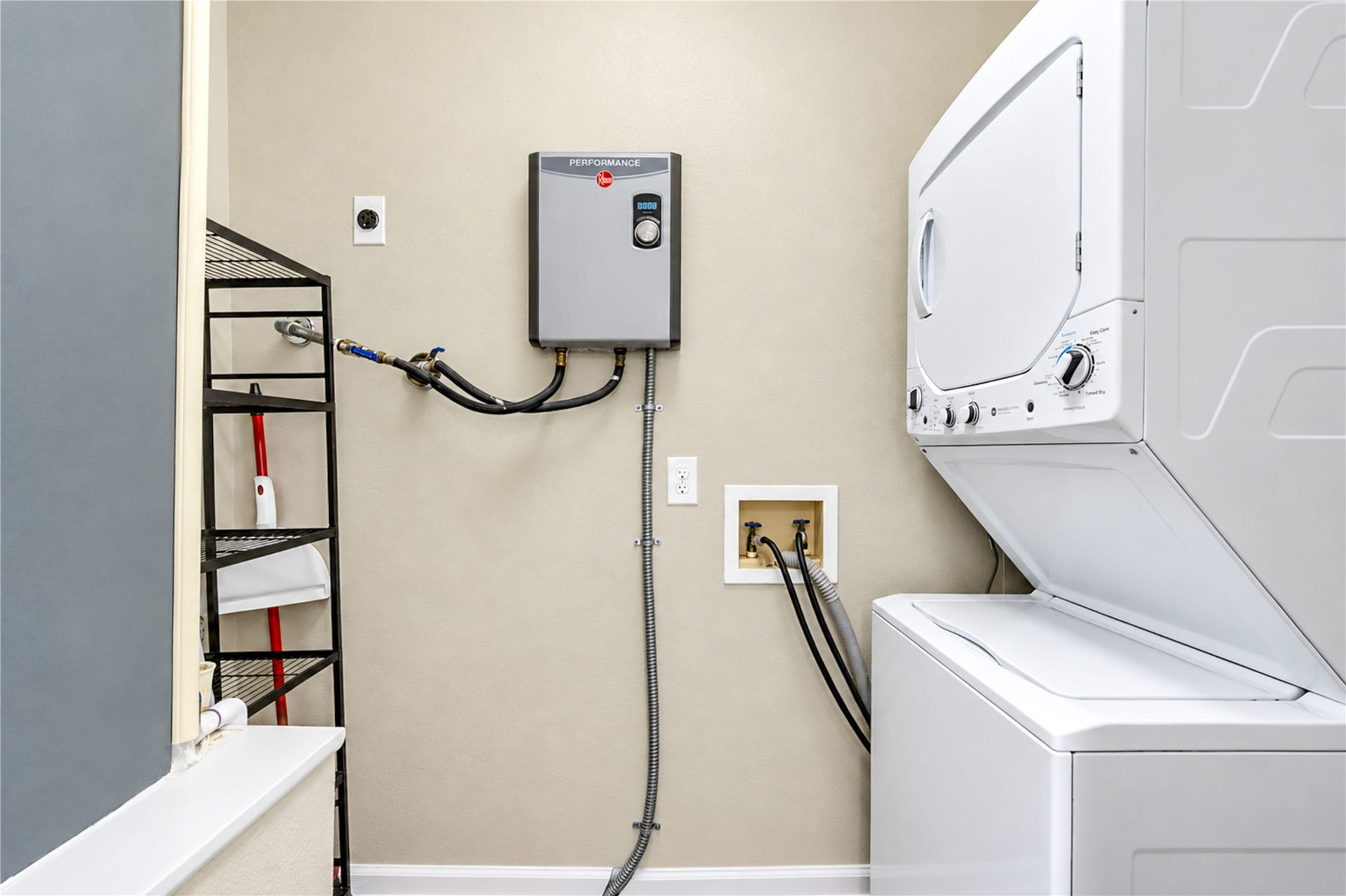 Tankless water heater and brand-new washer and dryer in utility room