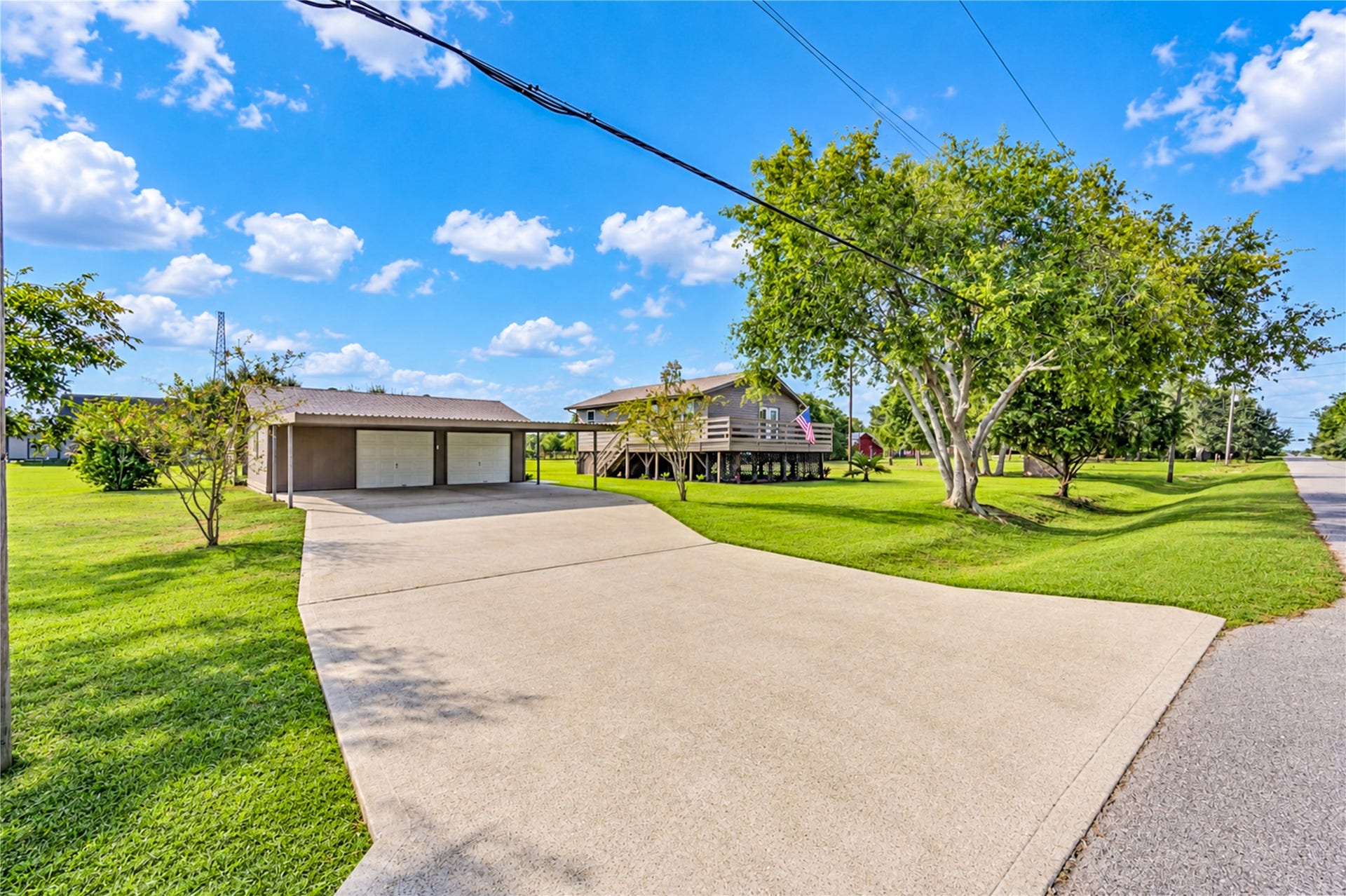 Oversized 2 car garage with extended carport covering