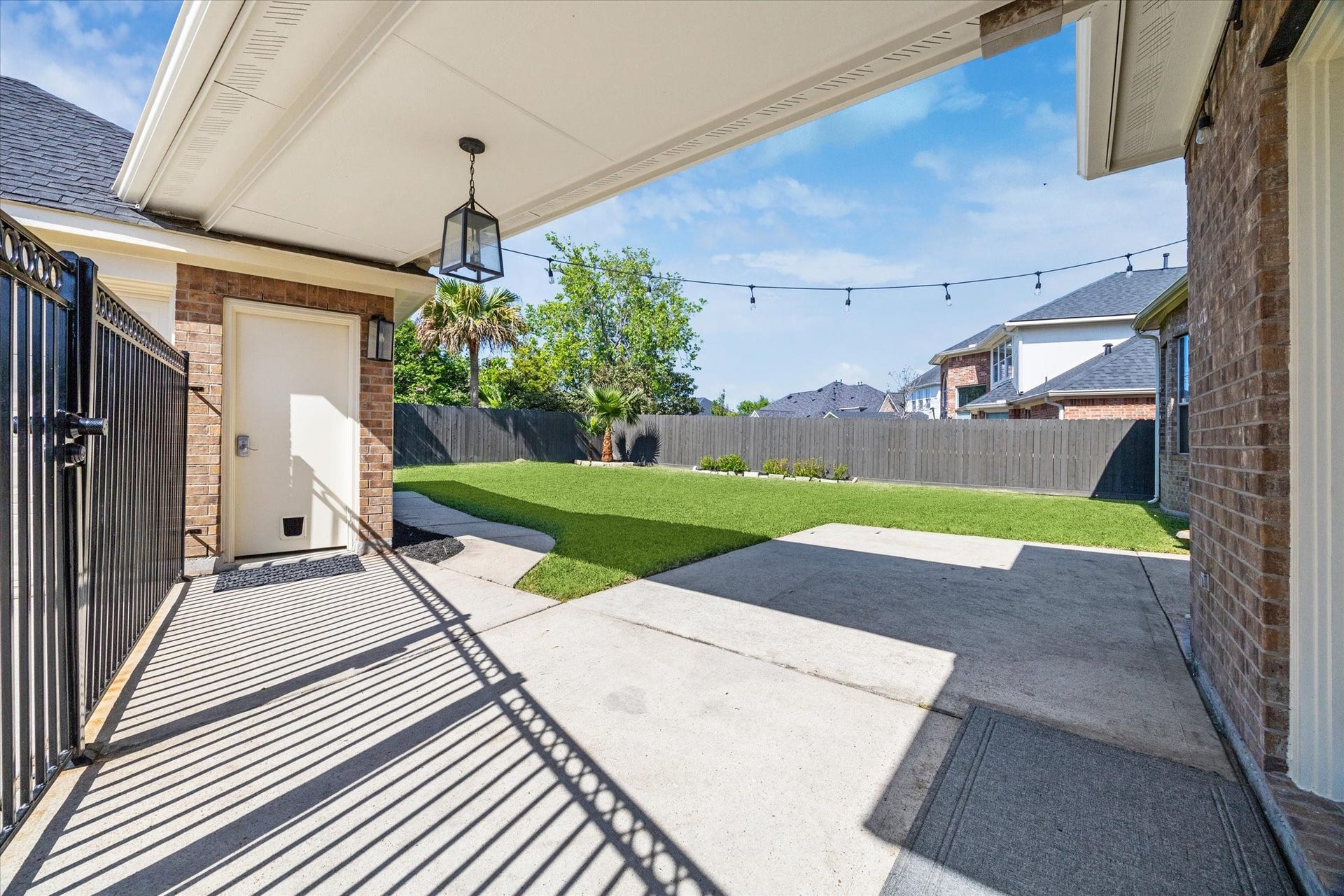 12006 Arcadia Bend Lane, Houston, TX 77041 Large concrete back patio w breezeway from garage & wrought iron gate