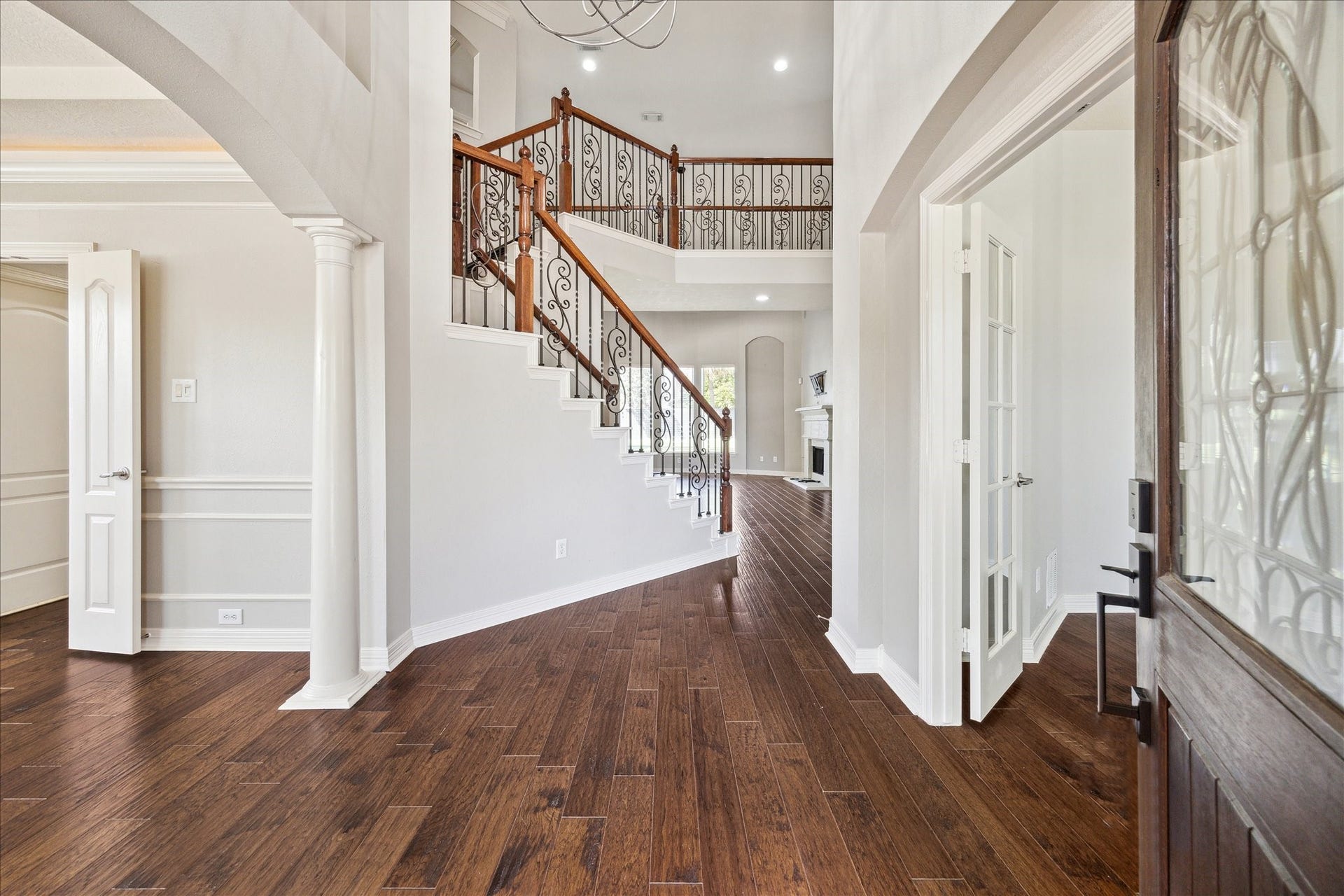 12006 Arcadia Bend Lane, Houston, TX 77041 Wrought iron staircase & hardwood floors throughout