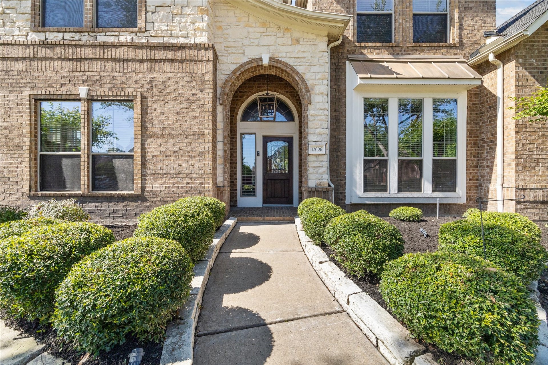 12006 Arcadia Bend Lane, Houston, TX 77041 Covered front porch & mahogany front door