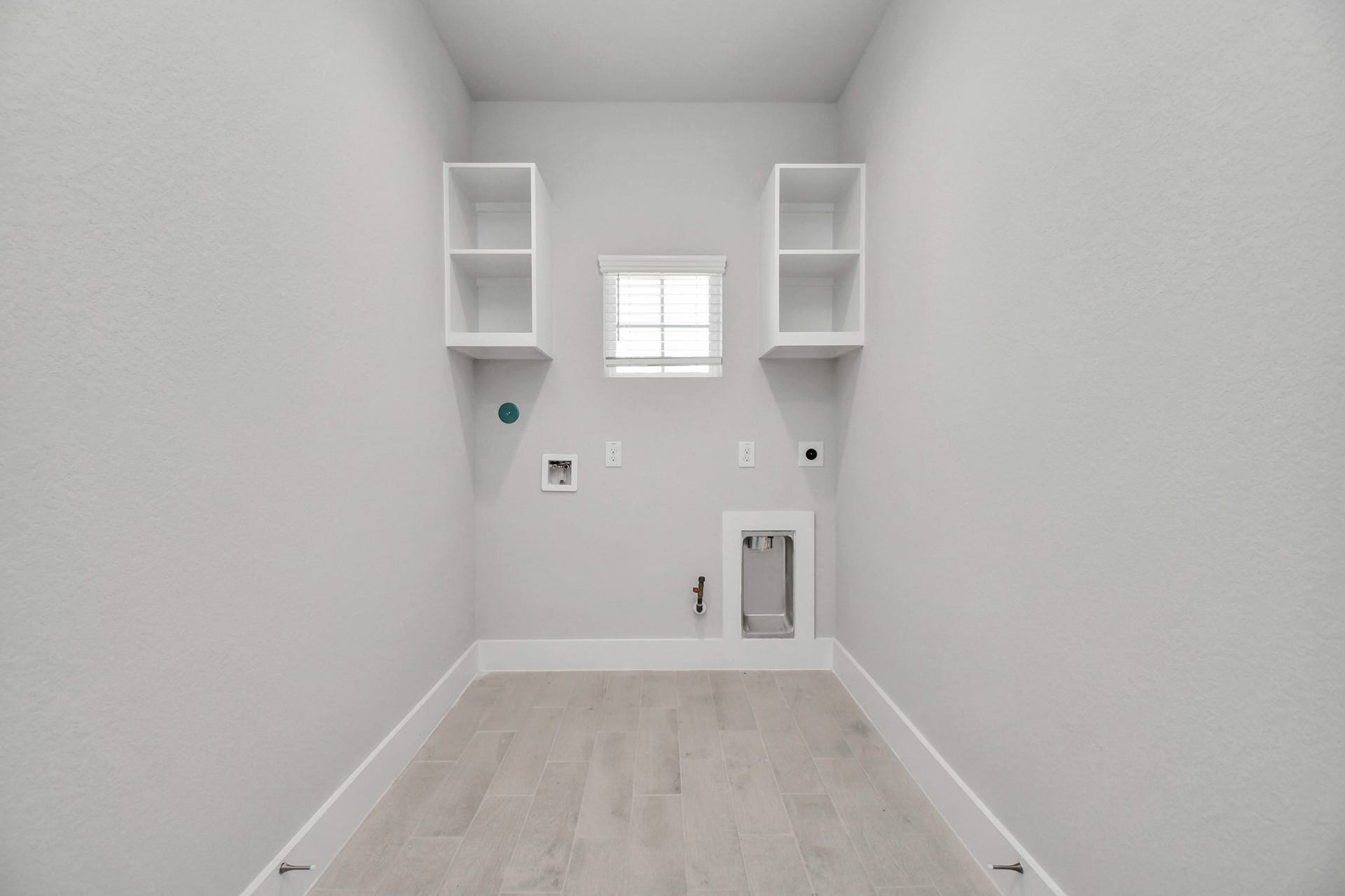 3114 Native Spring Drive, Spring, TX 77373 A perfect blend of functionality and comfort. Capture the essence of easy living with a first-floor laundry room, thoughtfully equipped with shelving for effortless organization. Both electric and gas connections available. Sample photo of completed home with similar floor plan. Actual colors and selections may vary.