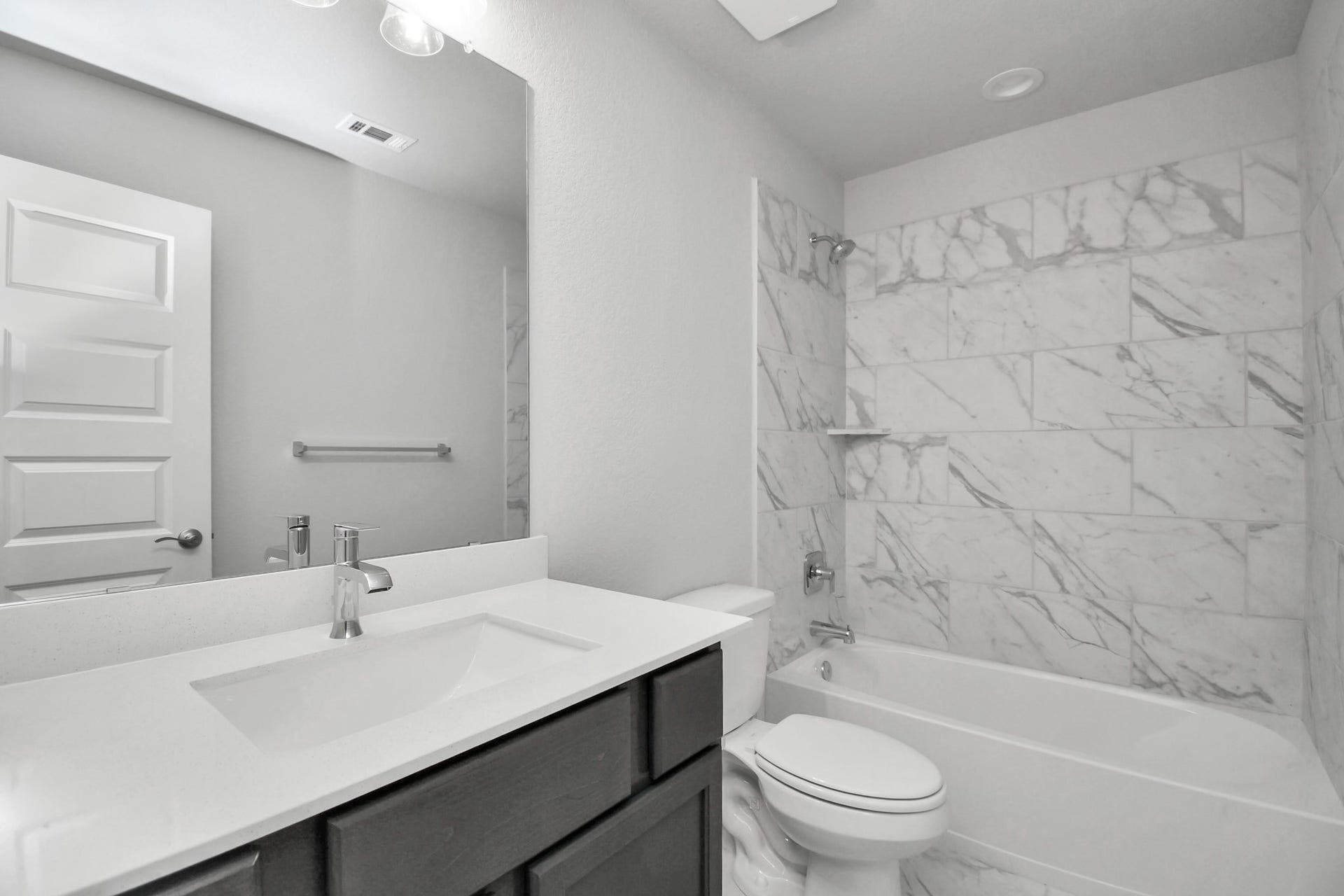 3114 Native Spring Drive, Spring, TX 77373 Secondary bath features tile flooring, bath/shower combo with tile surround, light stained wood cabinets, beautiful light countertop. Sample photo of completed home with similar floor plan. Actual colors and selections may vary.