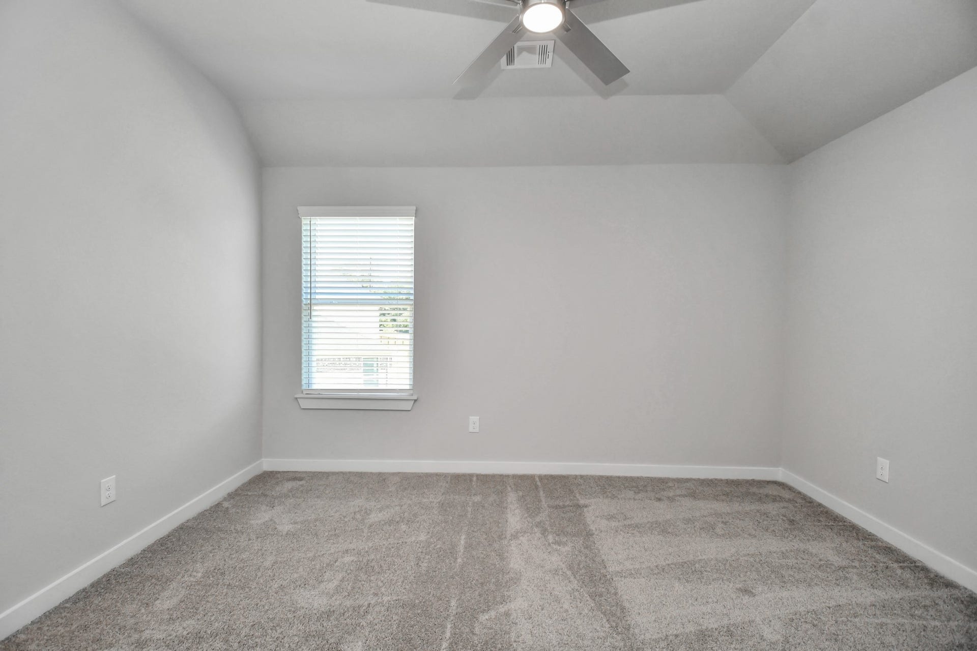 3114 Native Spring Drive, Spring, TX 77373 Secondary bedroom features plush carpeting, large windows that let in plenty of natural light, bright paint, and spacious closets. Sample photo of completed home with similar floor plan. Actual colors and selections may vary.