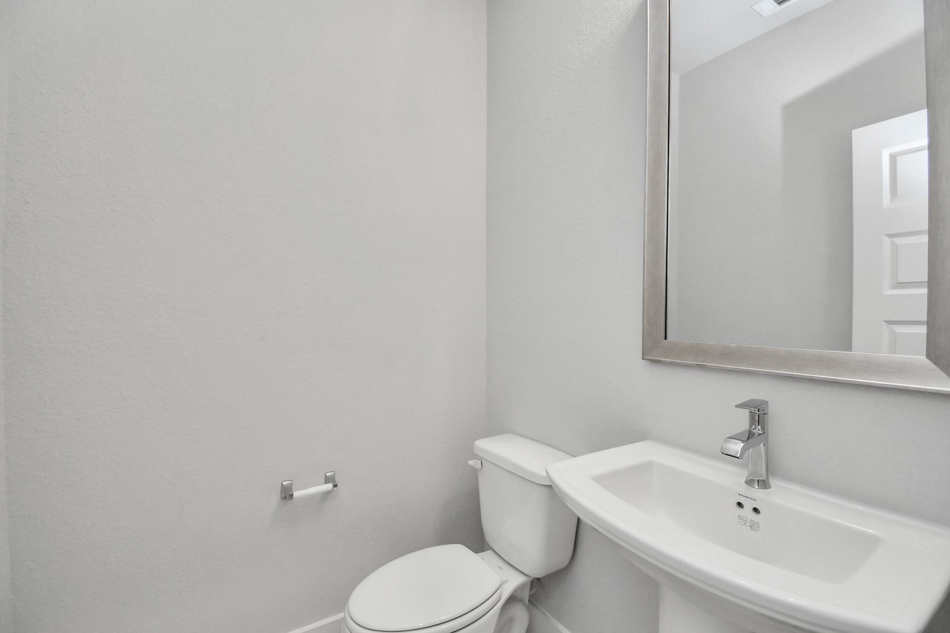 3114 Native Spring Drive, Spring, TX 77373 This half bathroom features a stylish pedestal sink, modern hardware, and bright recessed lighting, creating a sleek and inviting space. Sample photo of completed home with similar floor plan. Actual colors and selections may vary.
