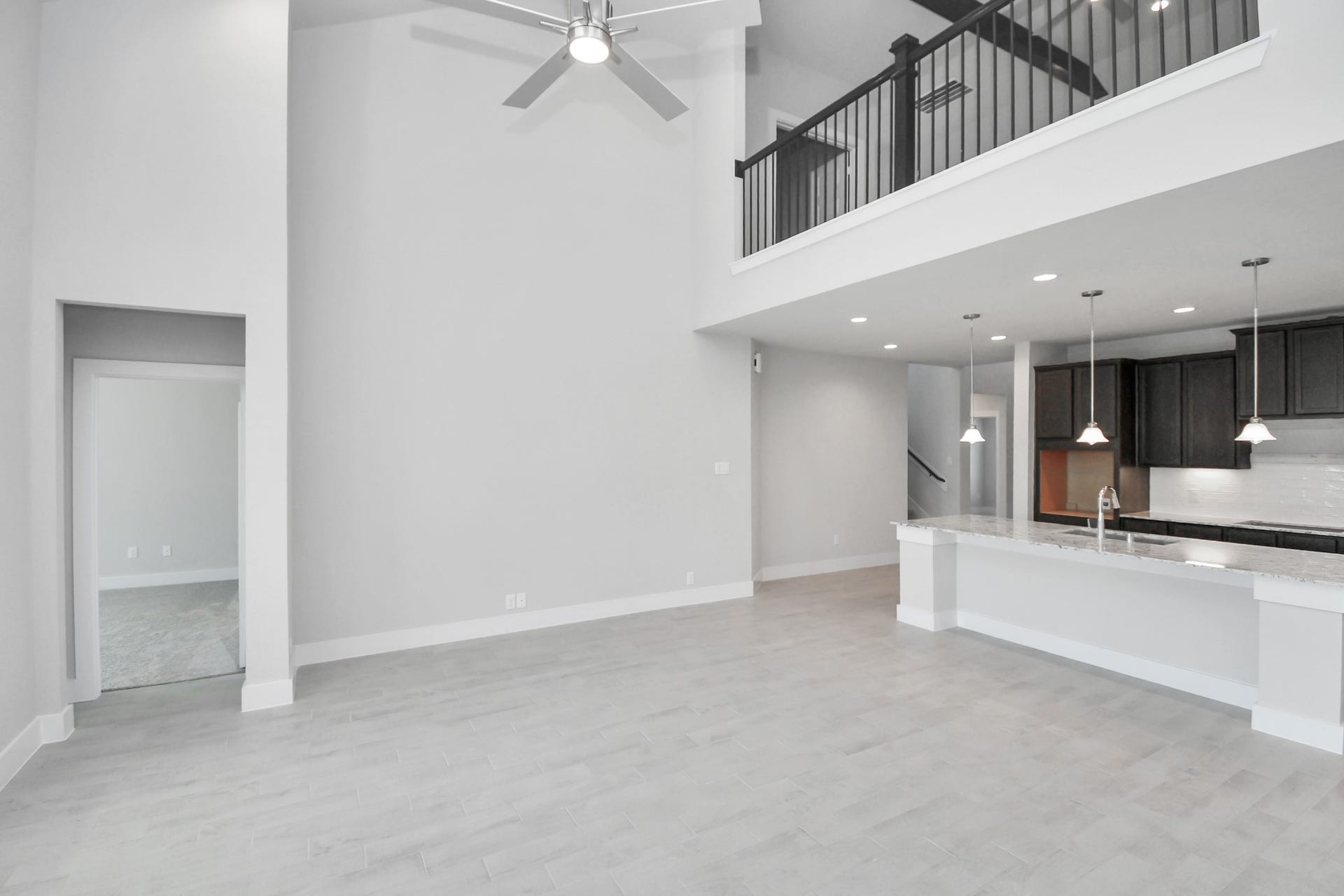 3114 Native Spring Drive, Spring, TX 77373 Family room flooded with natural light through the expansive windows. The premium tile flooring adds a touch of luxury to the space, creating the perfect setting for relaxing moments and cherished gatherings with loved ones Sample photo of completed home with similar floor plan. Actual colors and selections may vary.