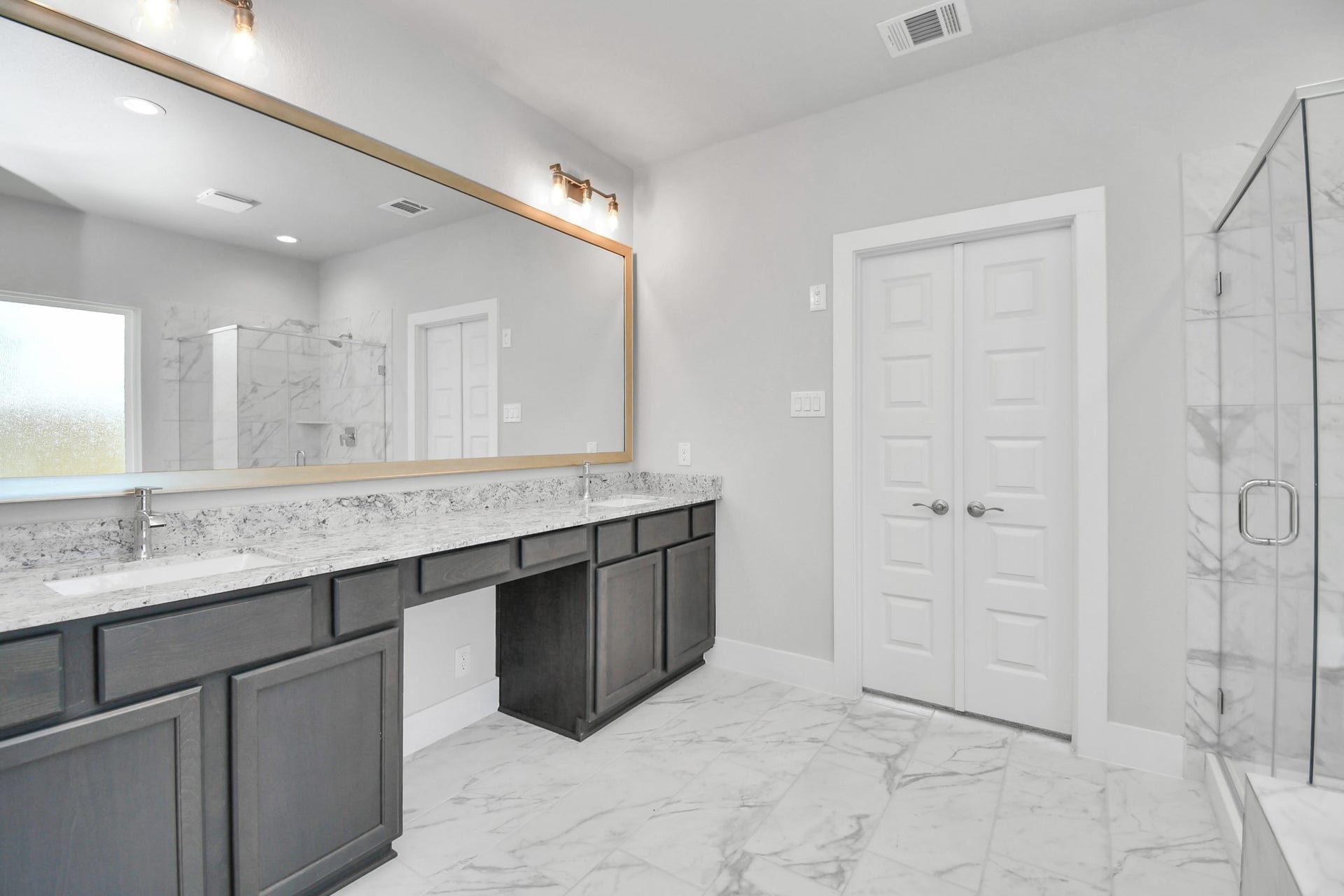 3114 Native Spring Drive, Spring, TX 77373 Elevate your daily routine at the elegant vanity, now equipped with double sinks, light countertops, modern hardware, and beautiful vanity lights. Sample photo of completed home with similar floor plan. Actual colors and selections may vary.