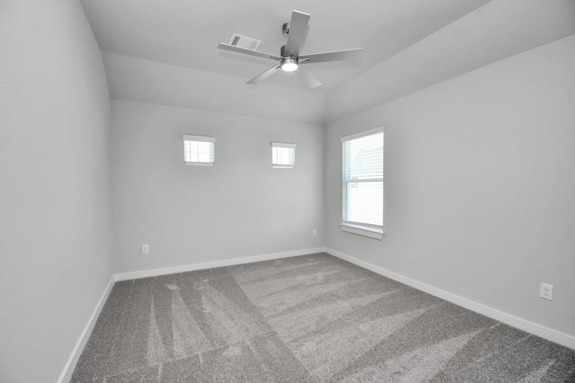 3114 Native Spring Drive, Spring, TX 77373 Secondary bedroom features plush carpeting, large windows that let in plenty of natural light, bright paint, and spacious closets. Sample photo of completed home with similar floor plan. Actual colors and selections may vary.