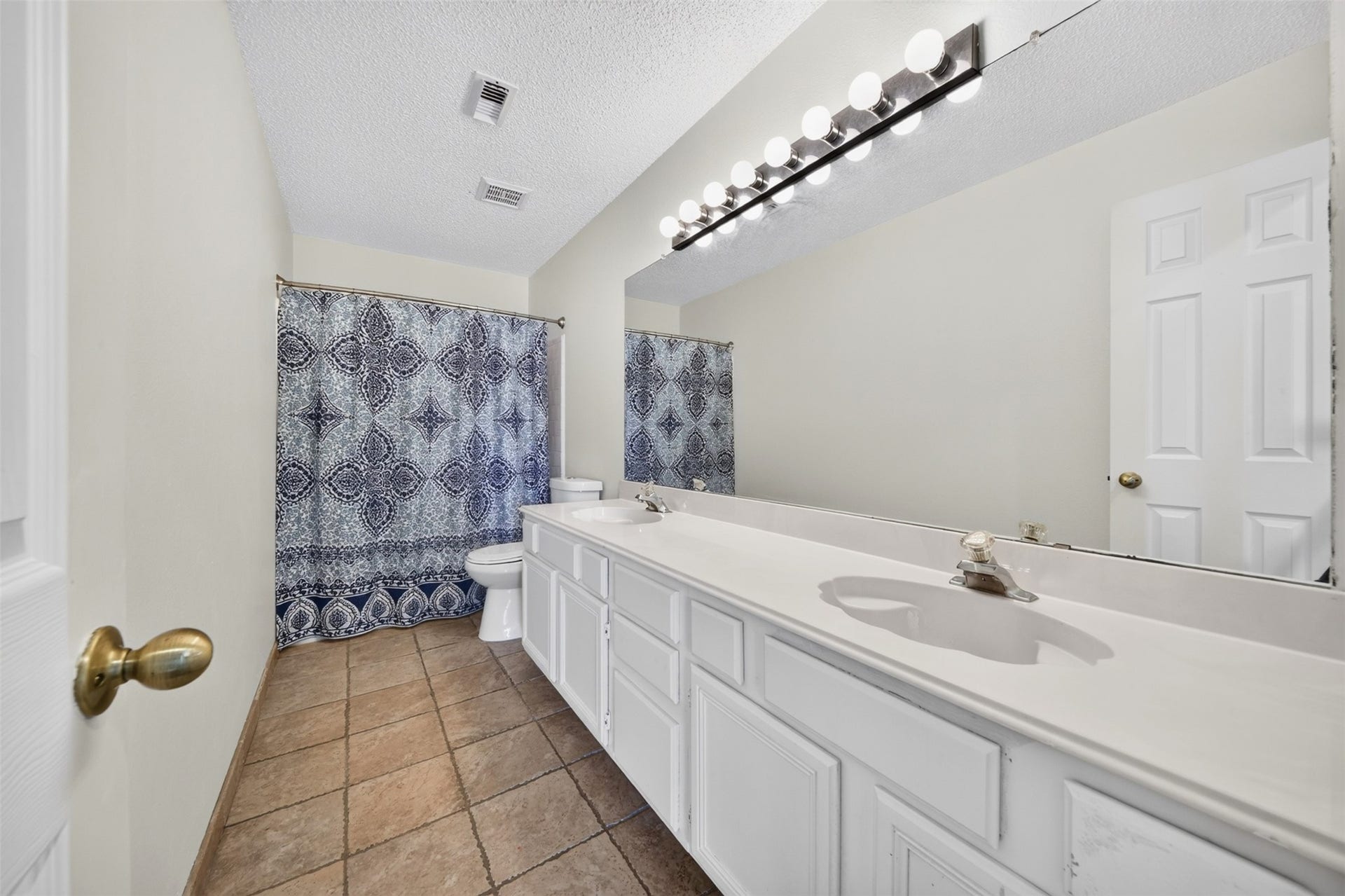 10215 Minturn Lane, Houston, TX 77064 Bathroom featuring a spacious vanity, decorative tile, and ample counter space.