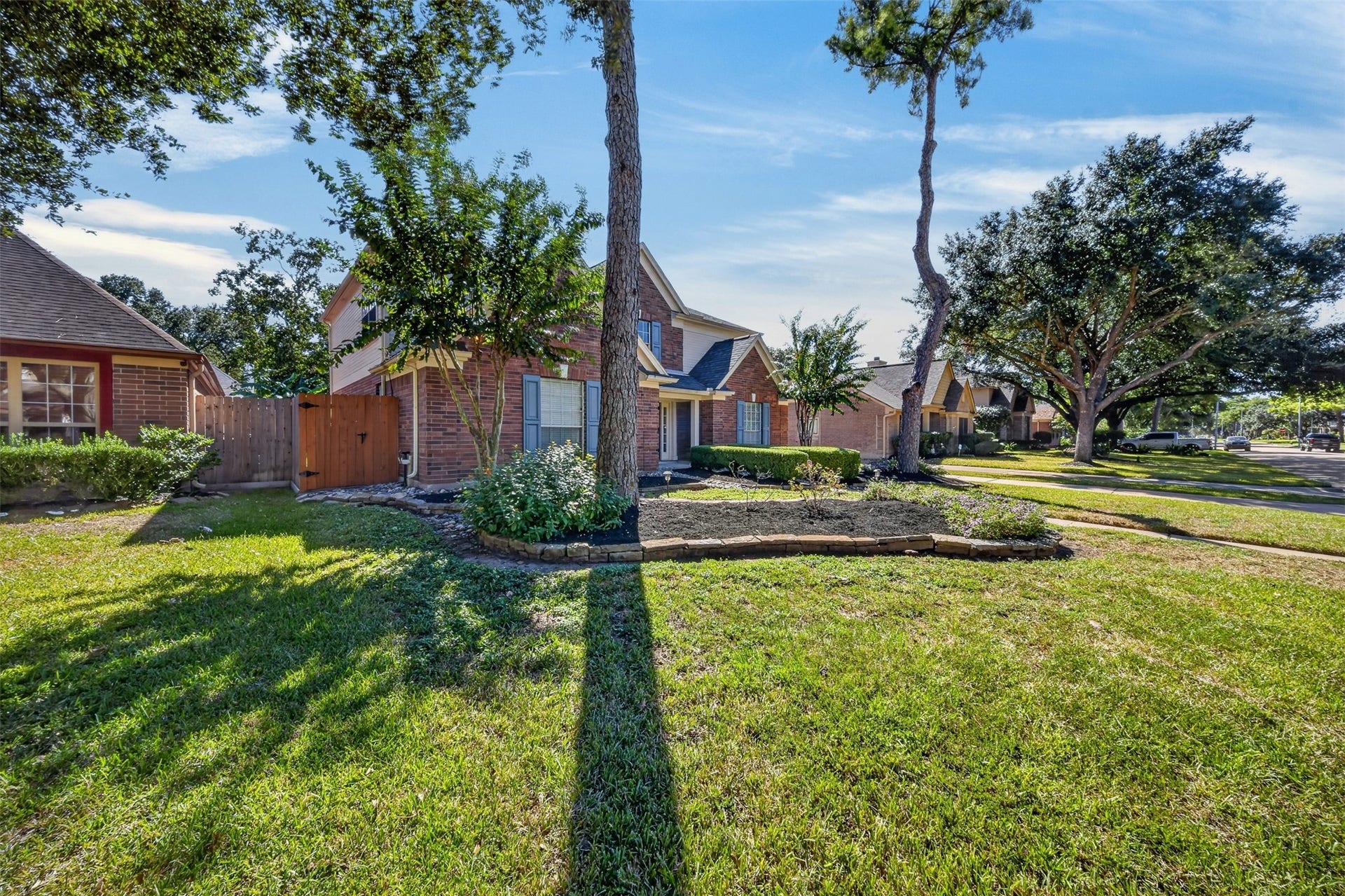 10215 Minturn Lane, Houston, TX 77064 Expansive front lawn with mature shade trees and attractive landscaping.