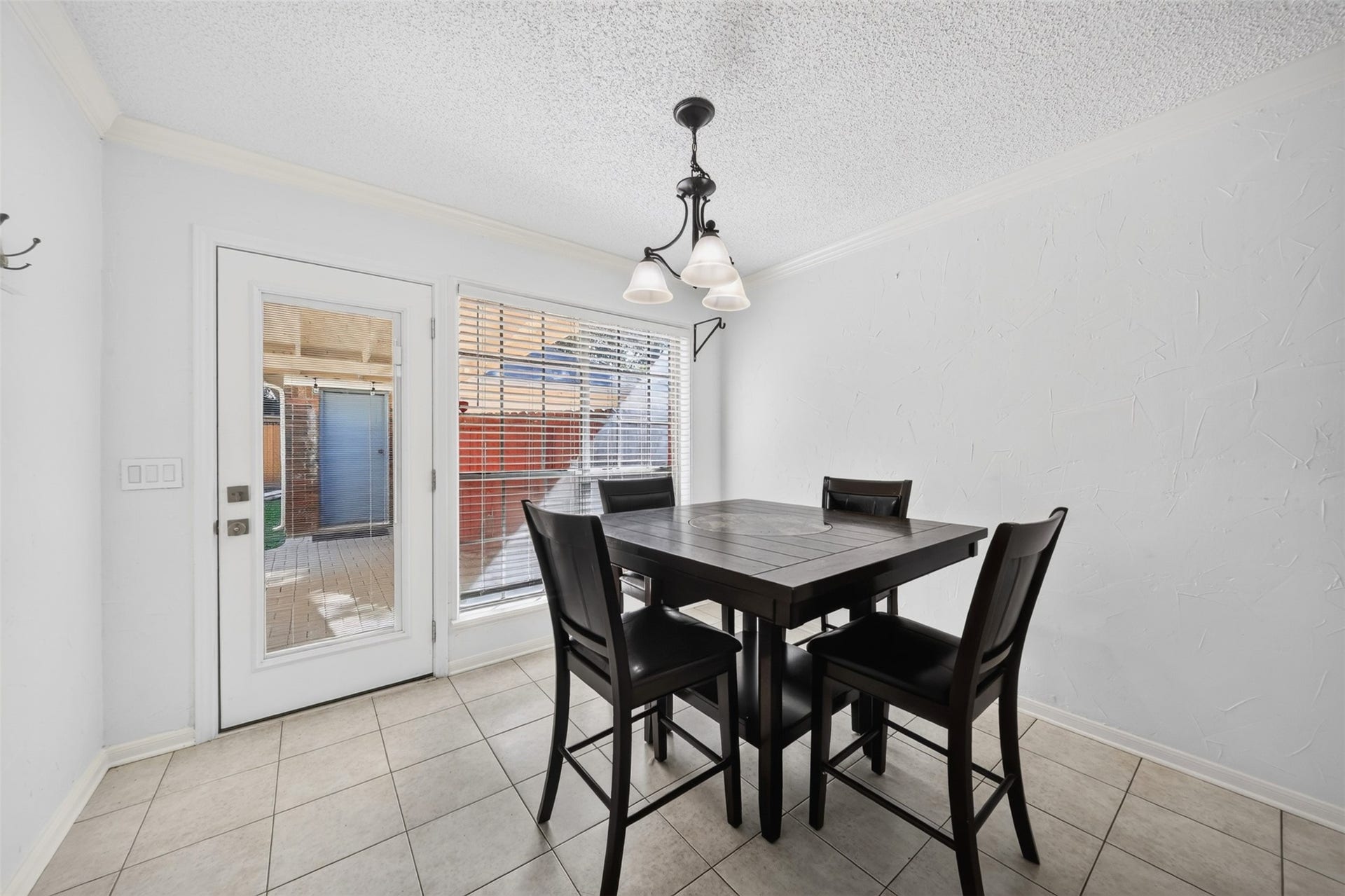 10215 Minturn Lane, Houston, TX 77064 Dining area with decorative lighting, neutral finishes, and French doors leading outdoors.