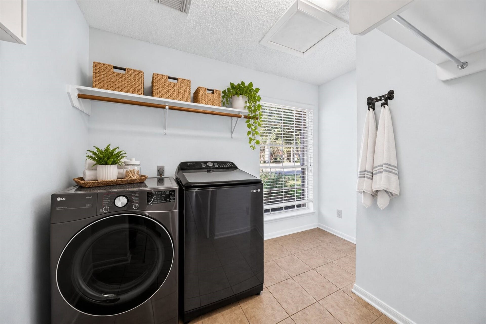 10215 Minturn Lane, Houston, TX 77064 Virtually staged laundry room showcasing functional storage and organization options.