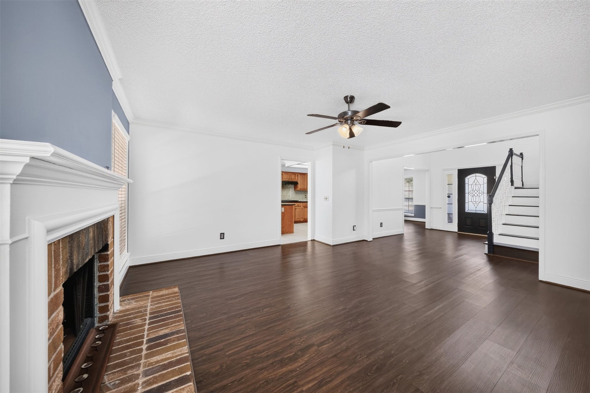 10215 Minturn Lane, Houston, TX 77064 Additional living room view highlighting the fireplace, ceiling fan, and generous space.