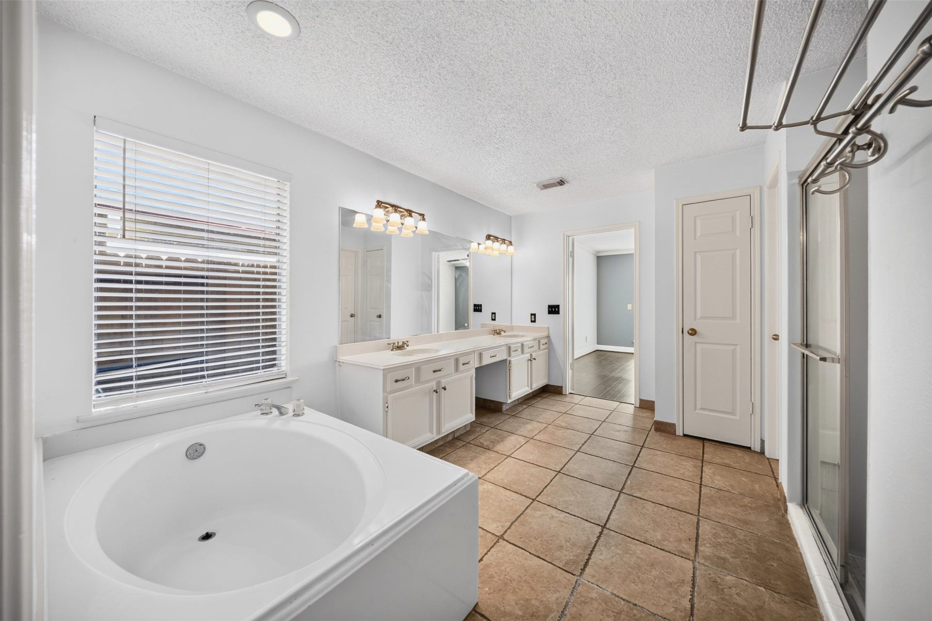 10215 Minturn Lane, Houston, TX 77064 Spacious bathroom featuring a soaking tub, separate shower, and dual vanities.