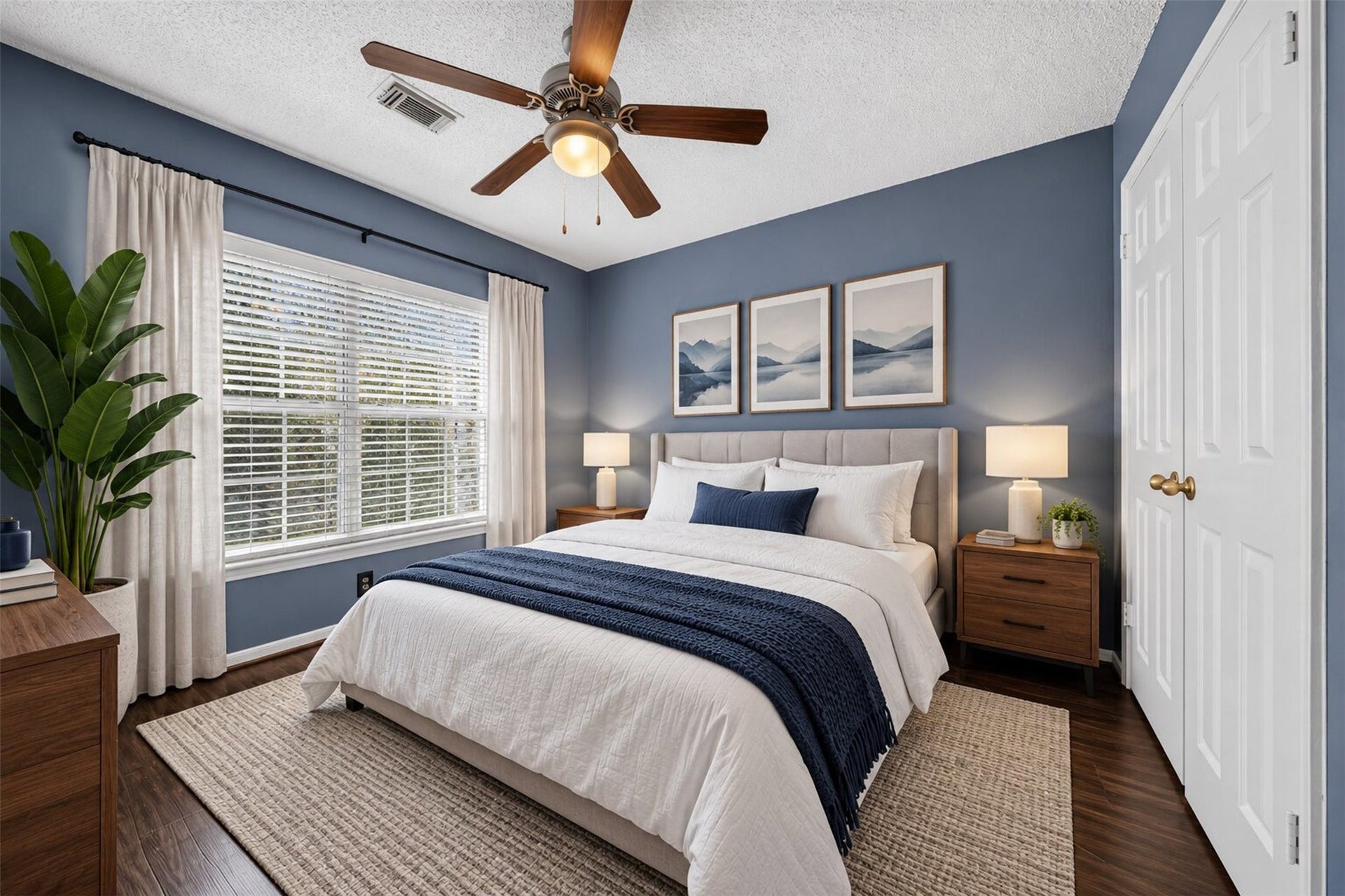 10215 Minturn Lane, Houston, TX 77064 Virtually staged bedroom showcasing a cozy layout with blue walls and natural light.