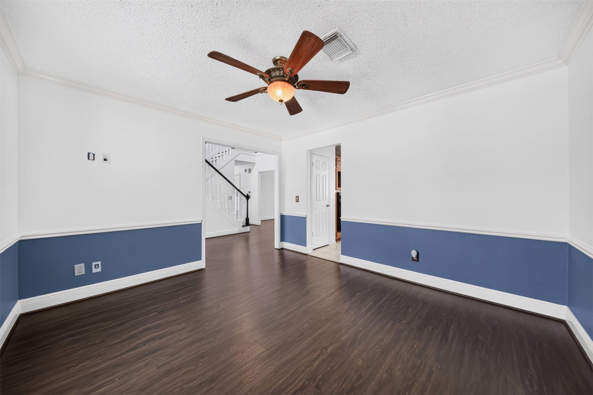 10215 Minturn Lane, Houston, TX 77064 Versatile flex room with wood look flooring, ceiling fan, and two-tone walls.