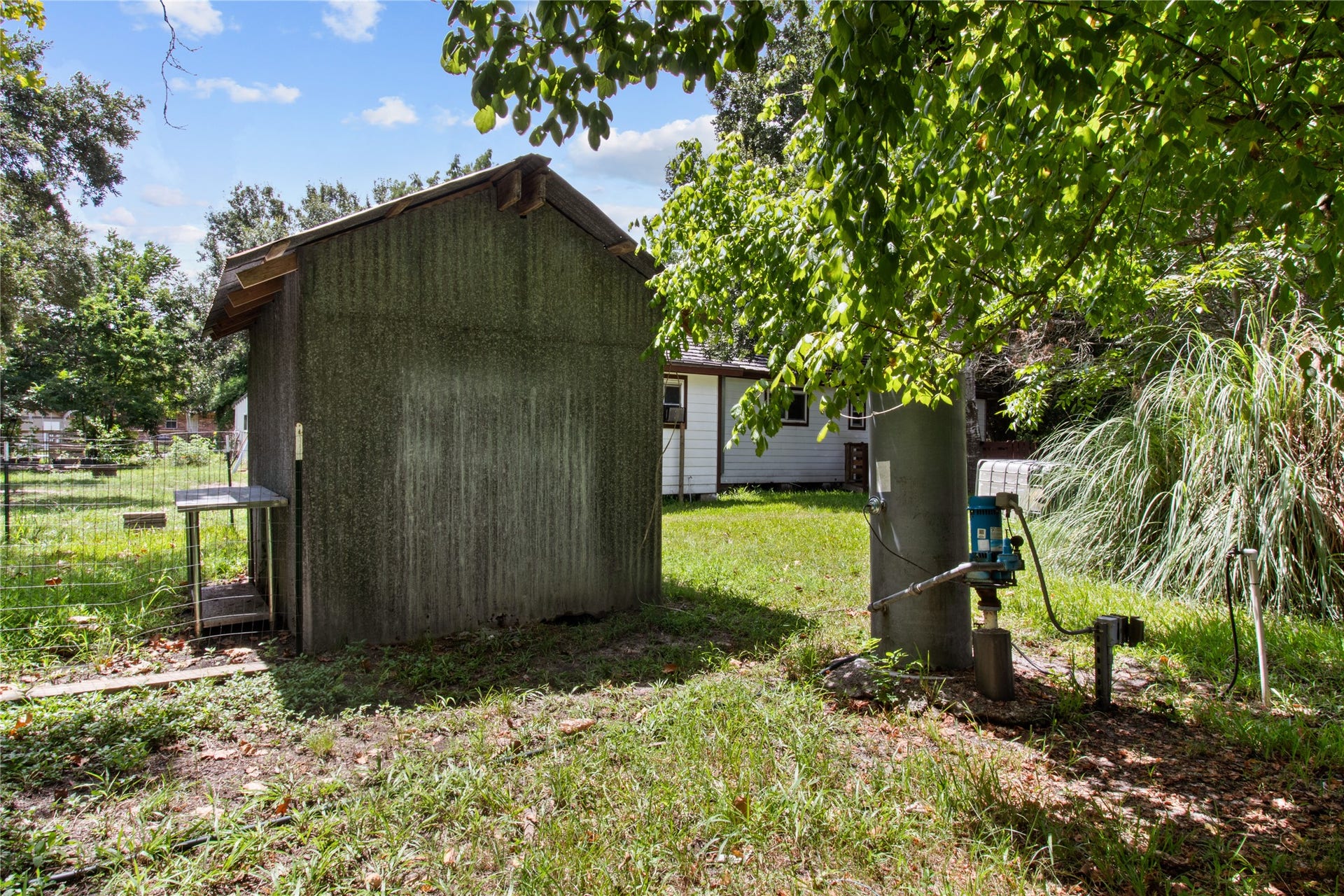 2305 Fm 1462 Road, Alvin, TX 77511 Spacious rear of property features a utility shed, mature trees, and a well pump that feeds the back side of the property. Imagine the many options for this functional outdoor space.