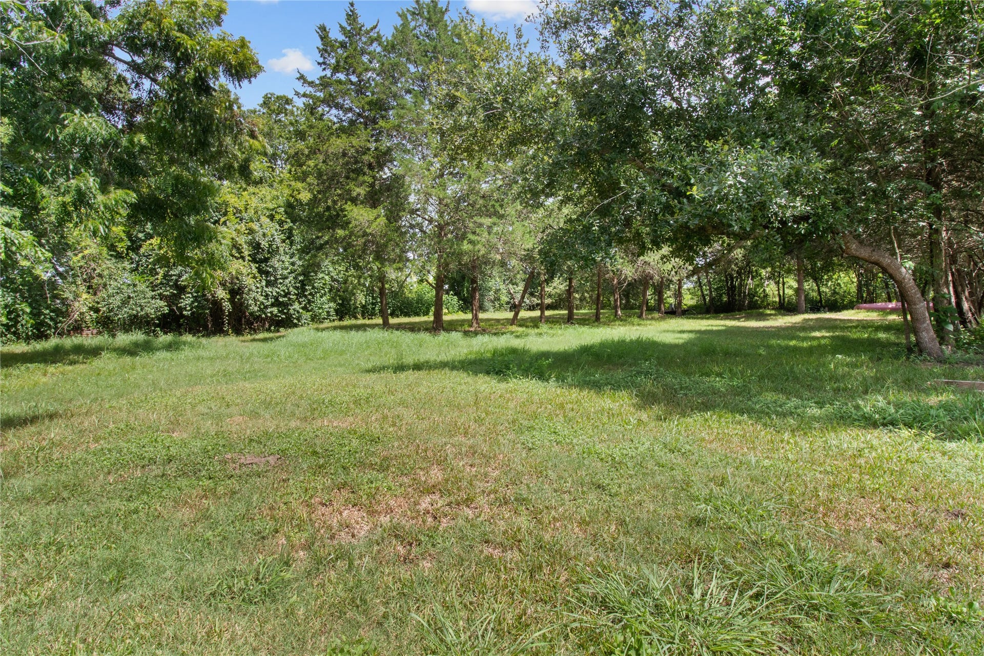 2305 Fm 1462 Road, Alvin, TX 77511 Mature trees provide natural screening throughout the property while the approximately 2-acre tract offers room to reimagine the site.