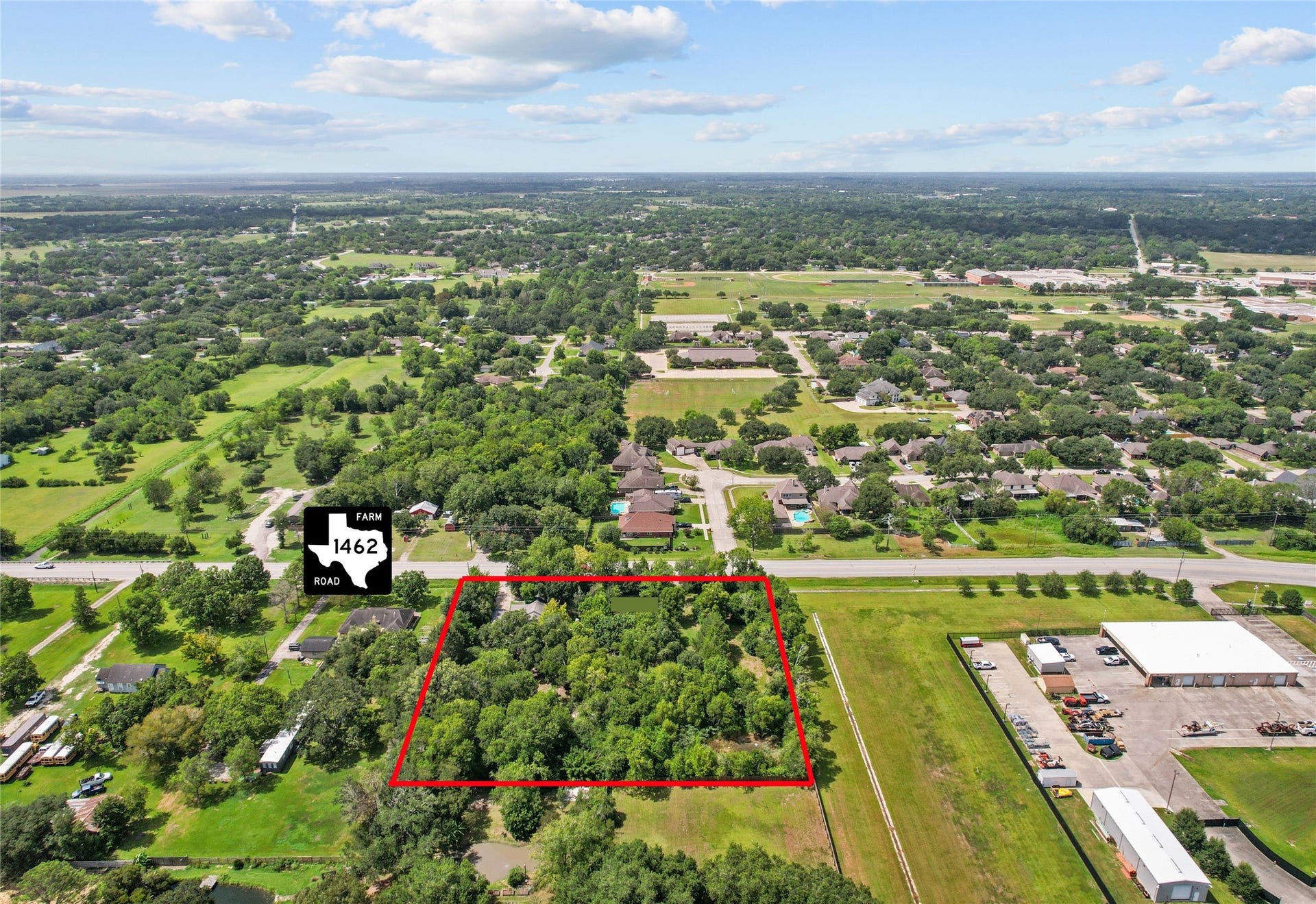 2305 Fm 1462 Road, Alvin, TX 77511 Expansive wooded lot outlined in red, offering privacy and potential, conveniently located acess to FM 1462.
